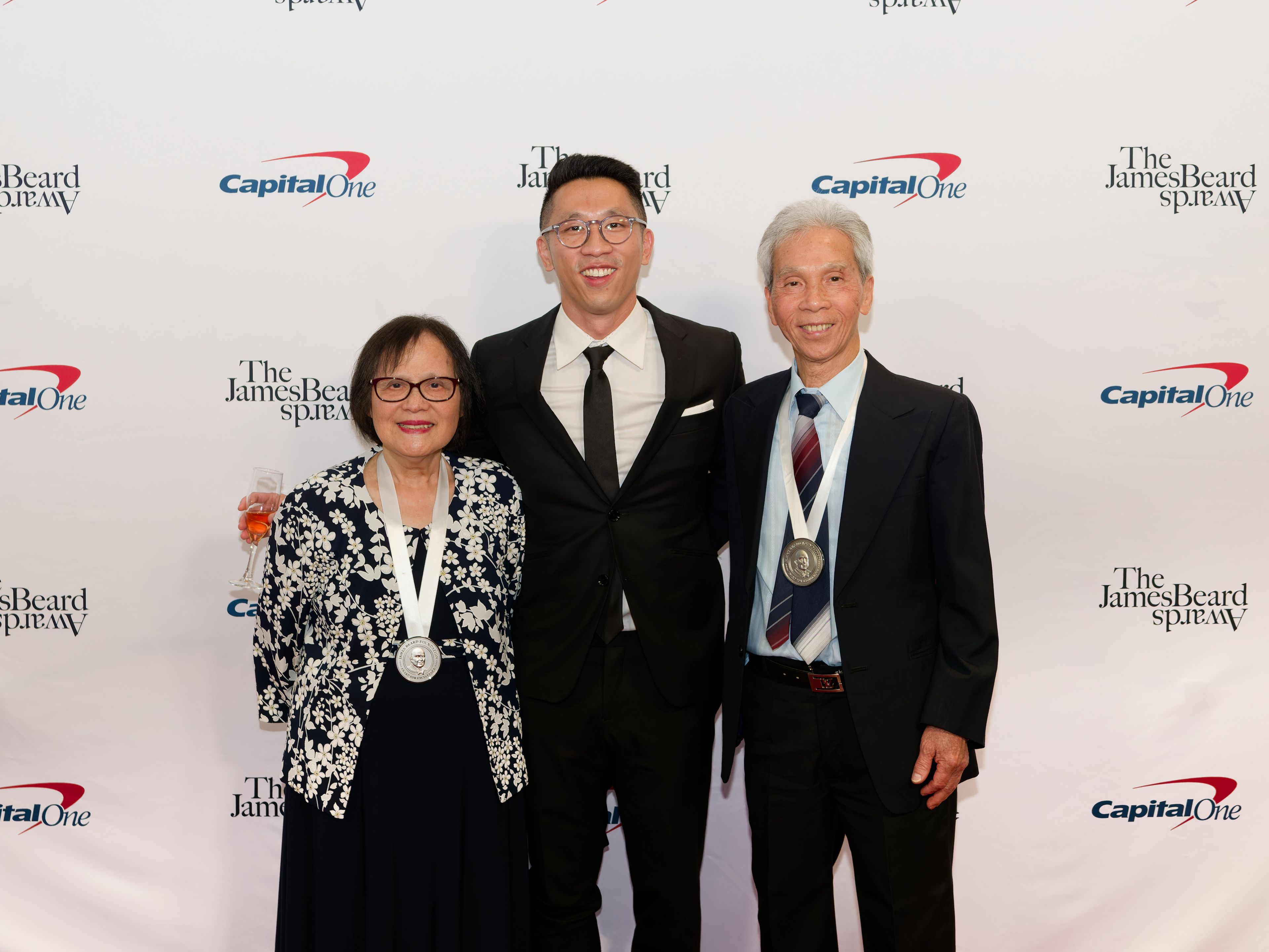 Randy Lau with his parents in front of the 2024 James Beard Media Awards step and repeat (photo: Galdones Photography/JBF)