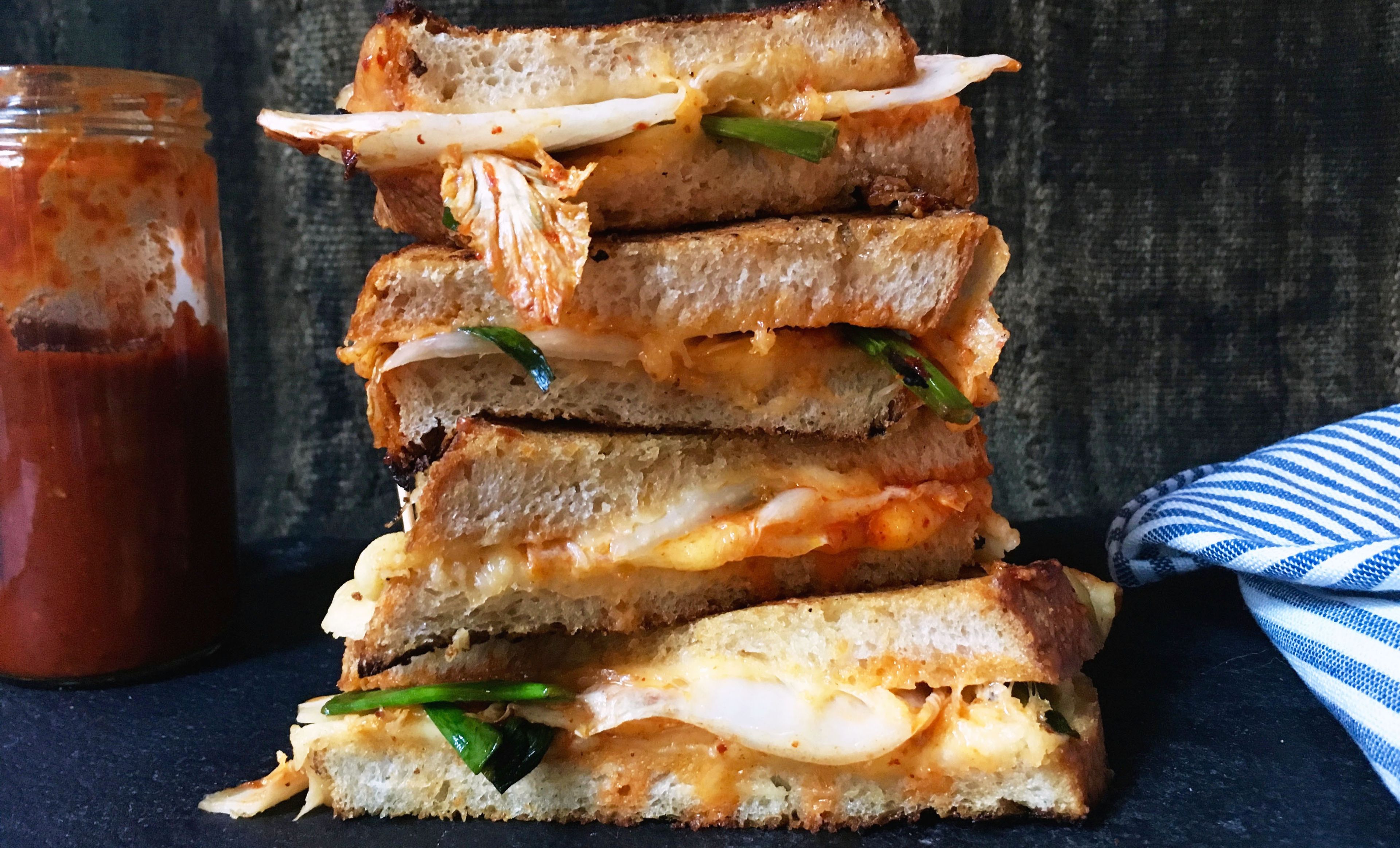 Kimchi grilled cheese sandwiches stacked on each other