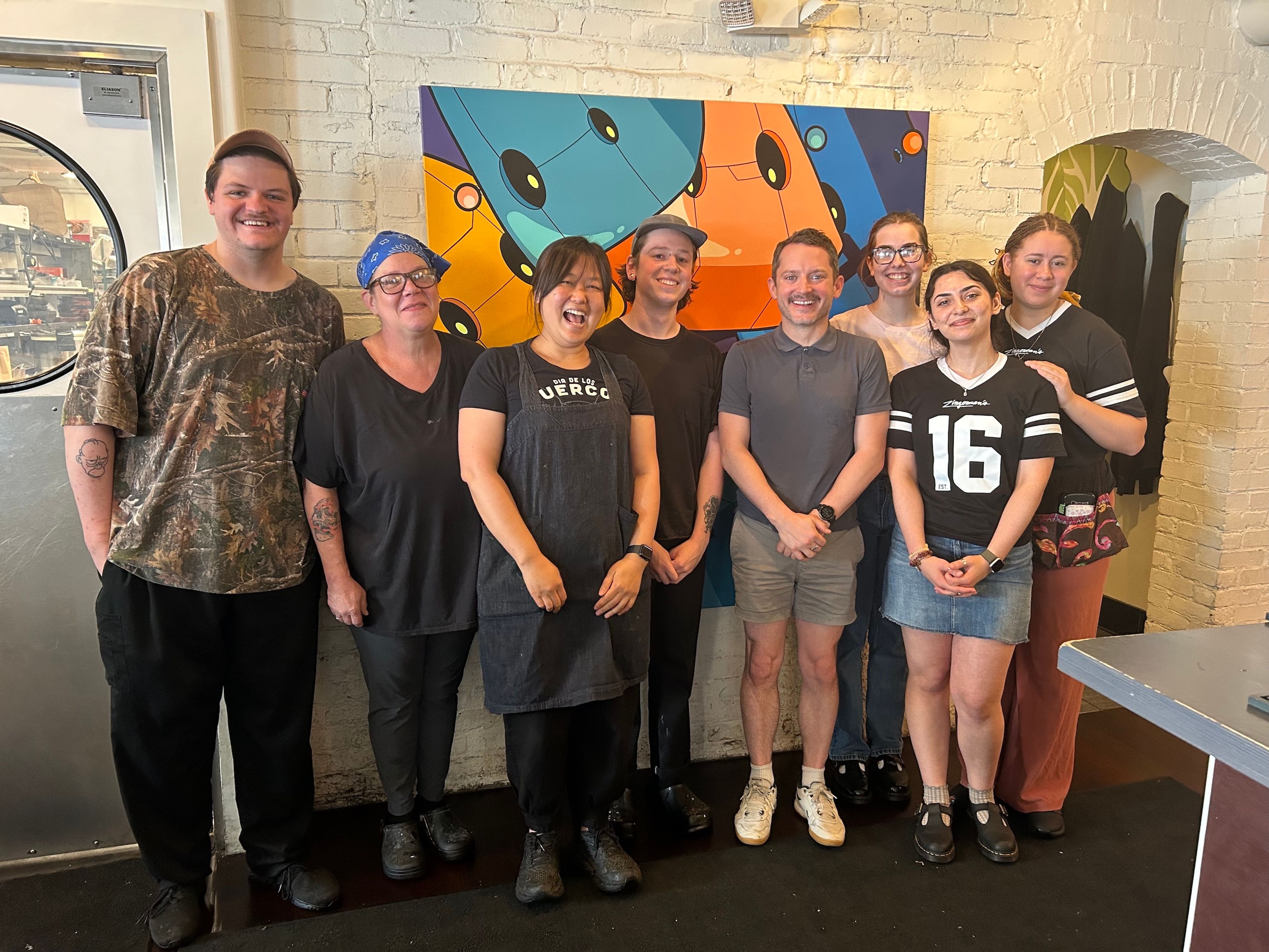 Kim and her team with actor Elijah Wood. (Photo courtesy of Ji Hye Kim)