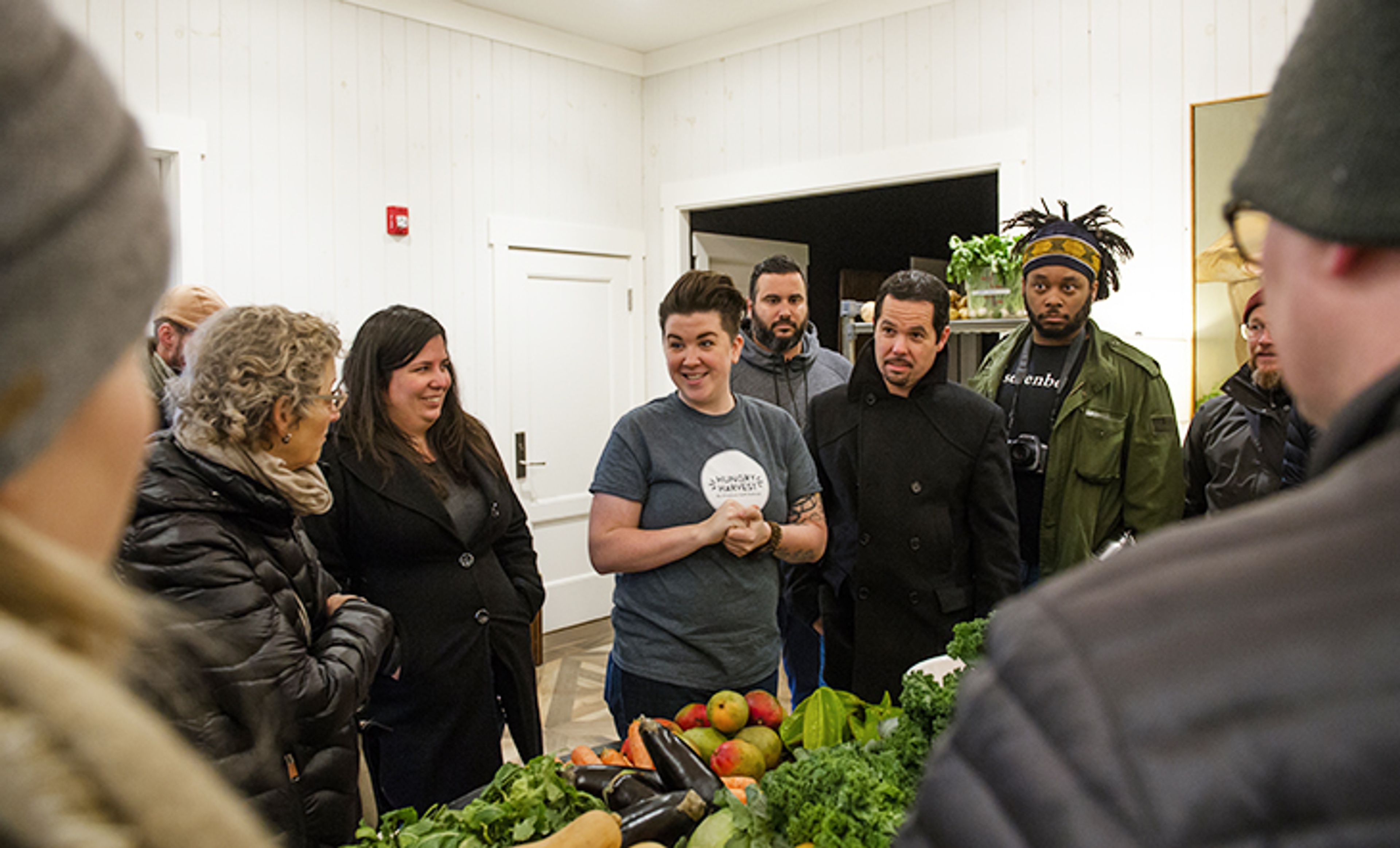 Chefs around produce on a table