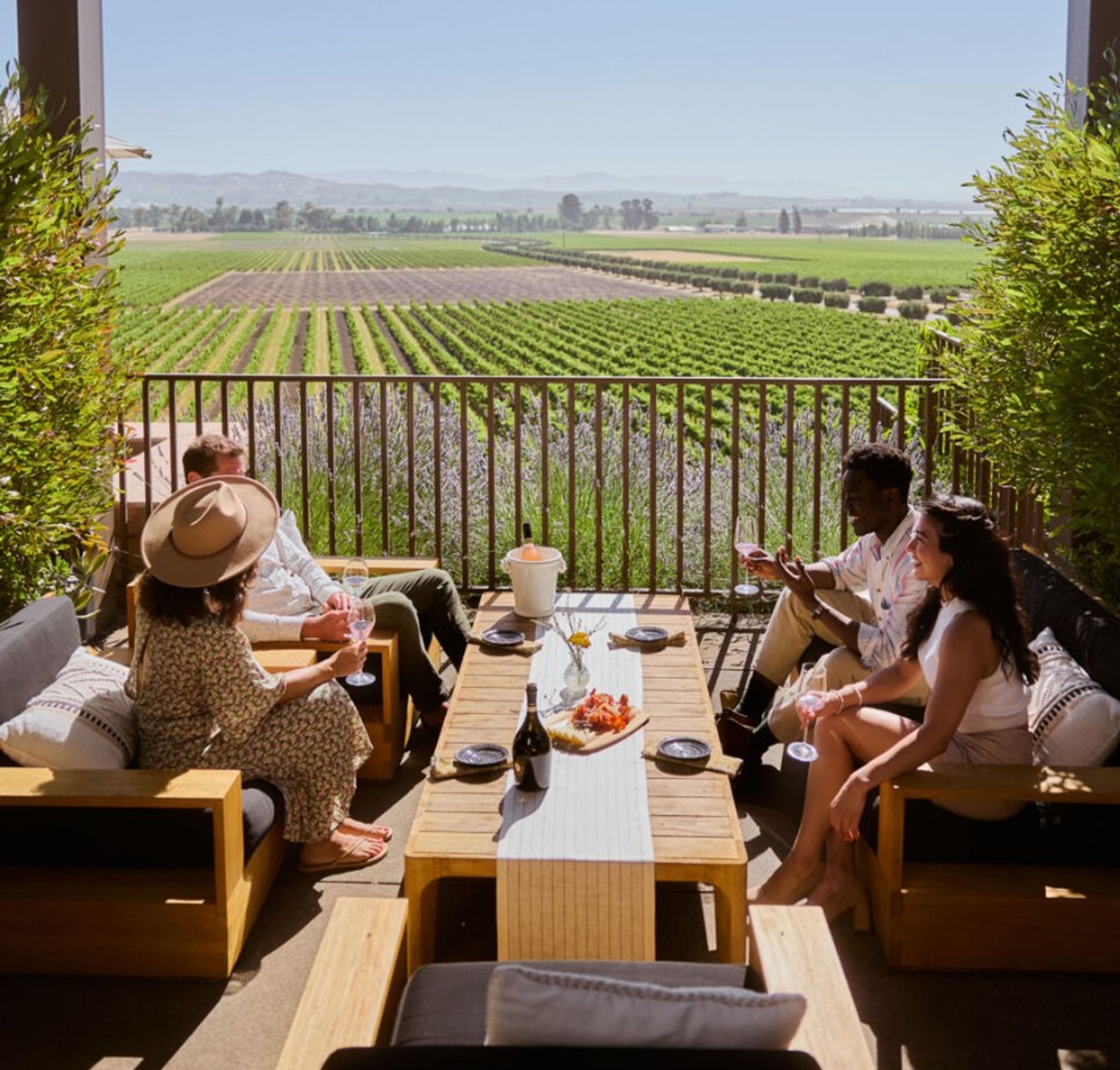 Four people enjoying a terrace by a winery