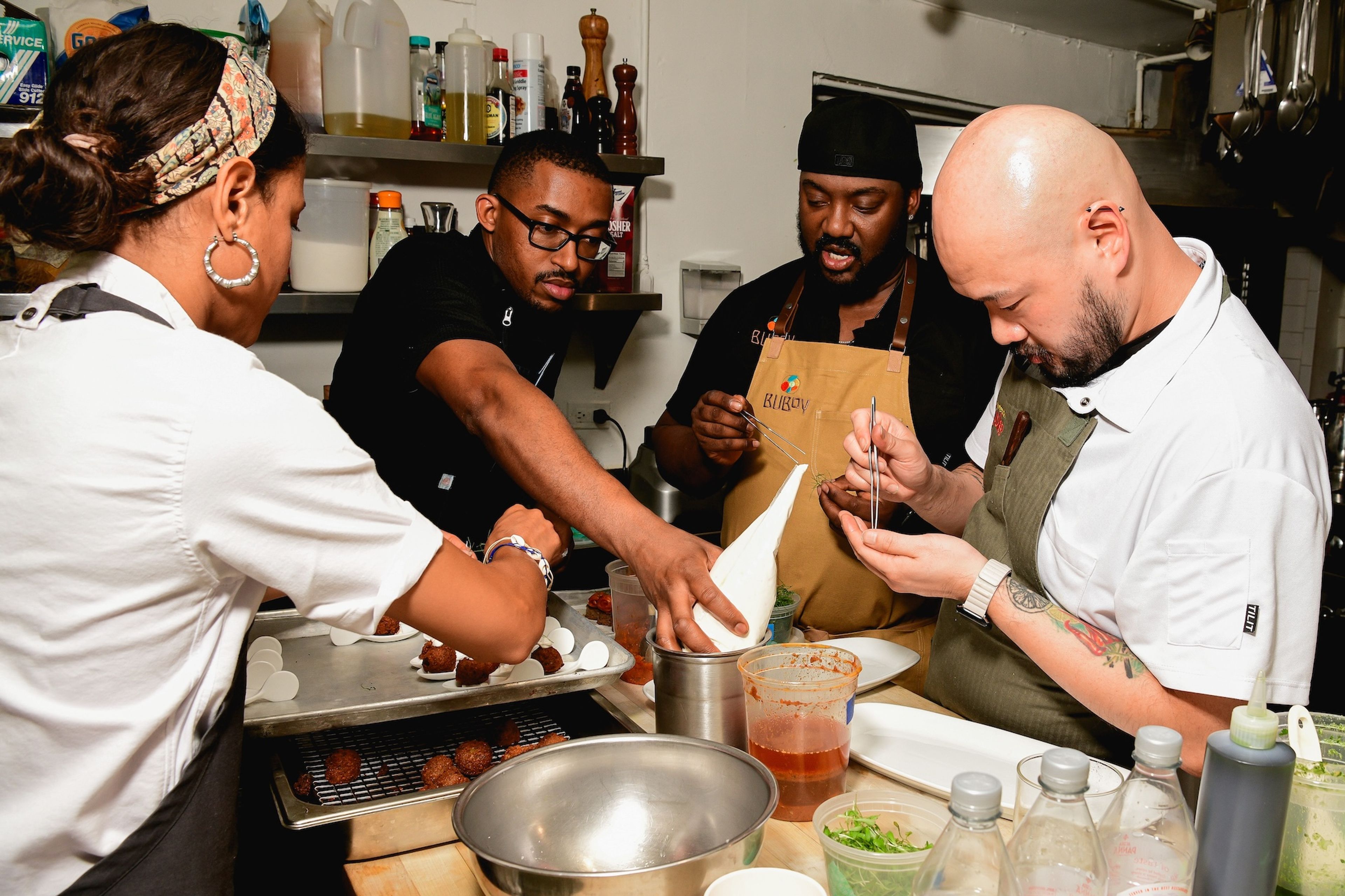 Tristen plates canapés with, from left, Lana Lagomarsini, Anthony Jones, and Henry Lu. (Photo: Max Flatow)