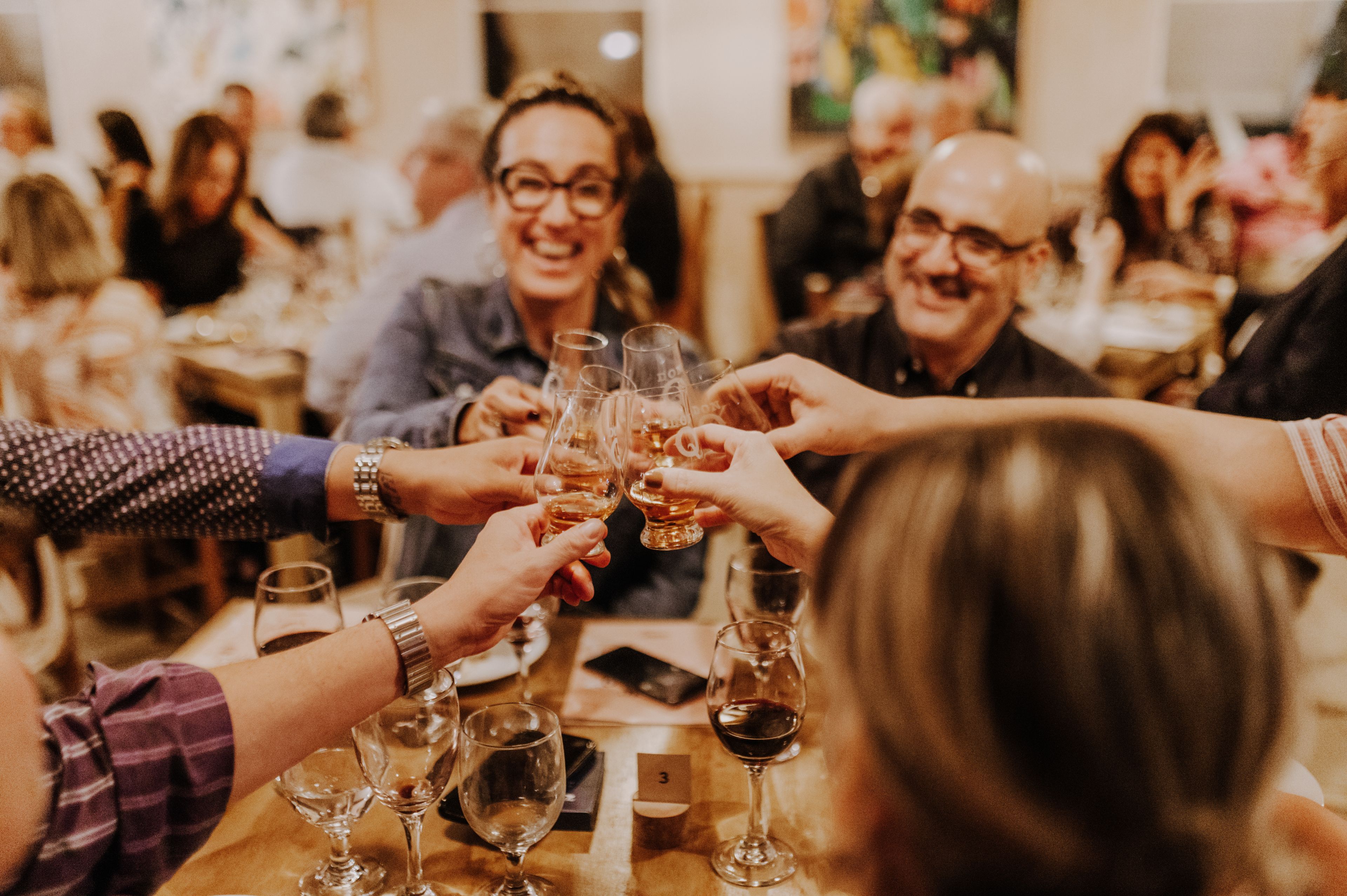 Group of people clinking glasses at a table