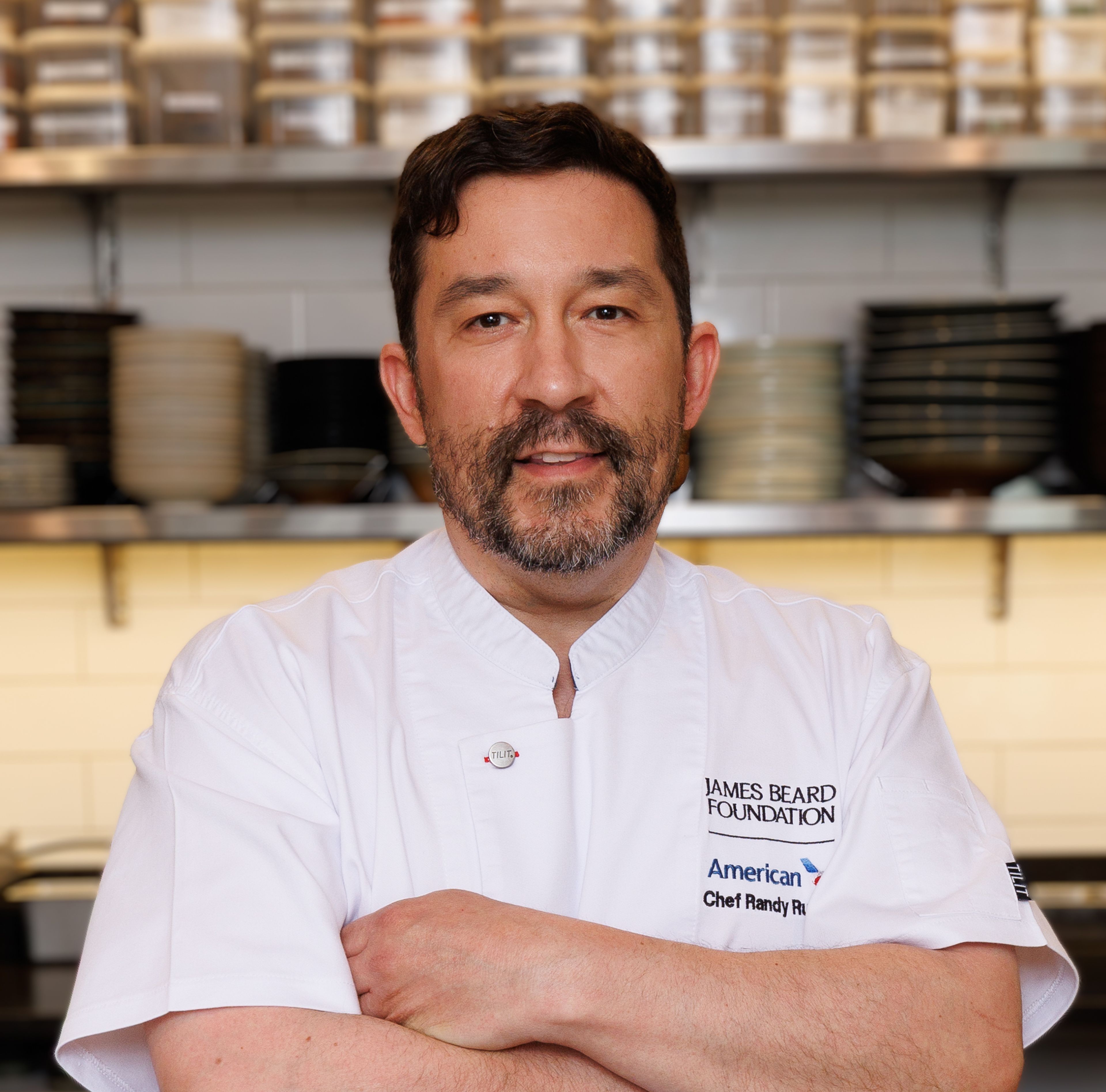 Chef Randy Rucker with a yogurt bowl in a American Airlines and JBF branded chef coat