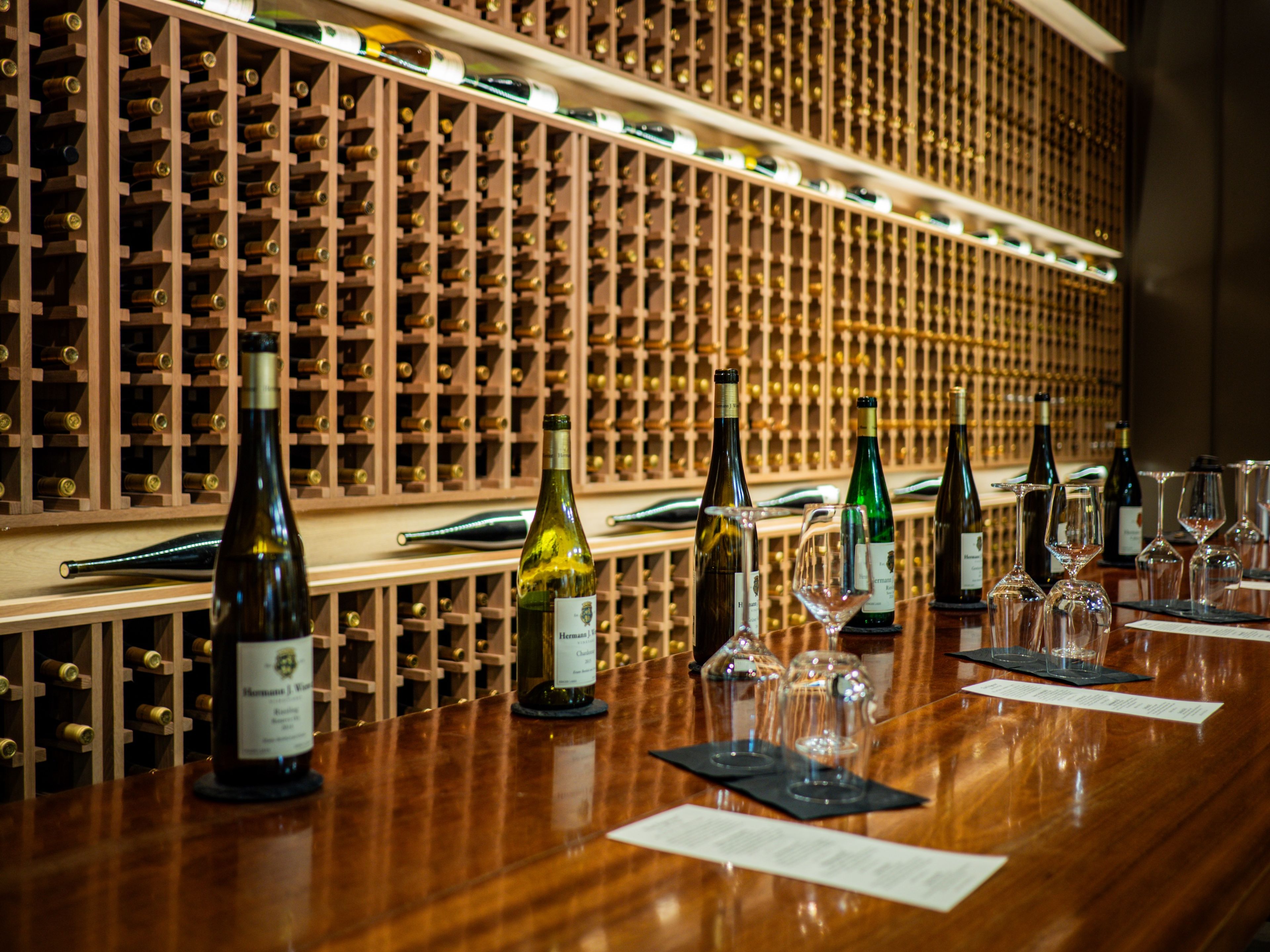 A stocked wine cellar bar set with various wines and wine tasting materials