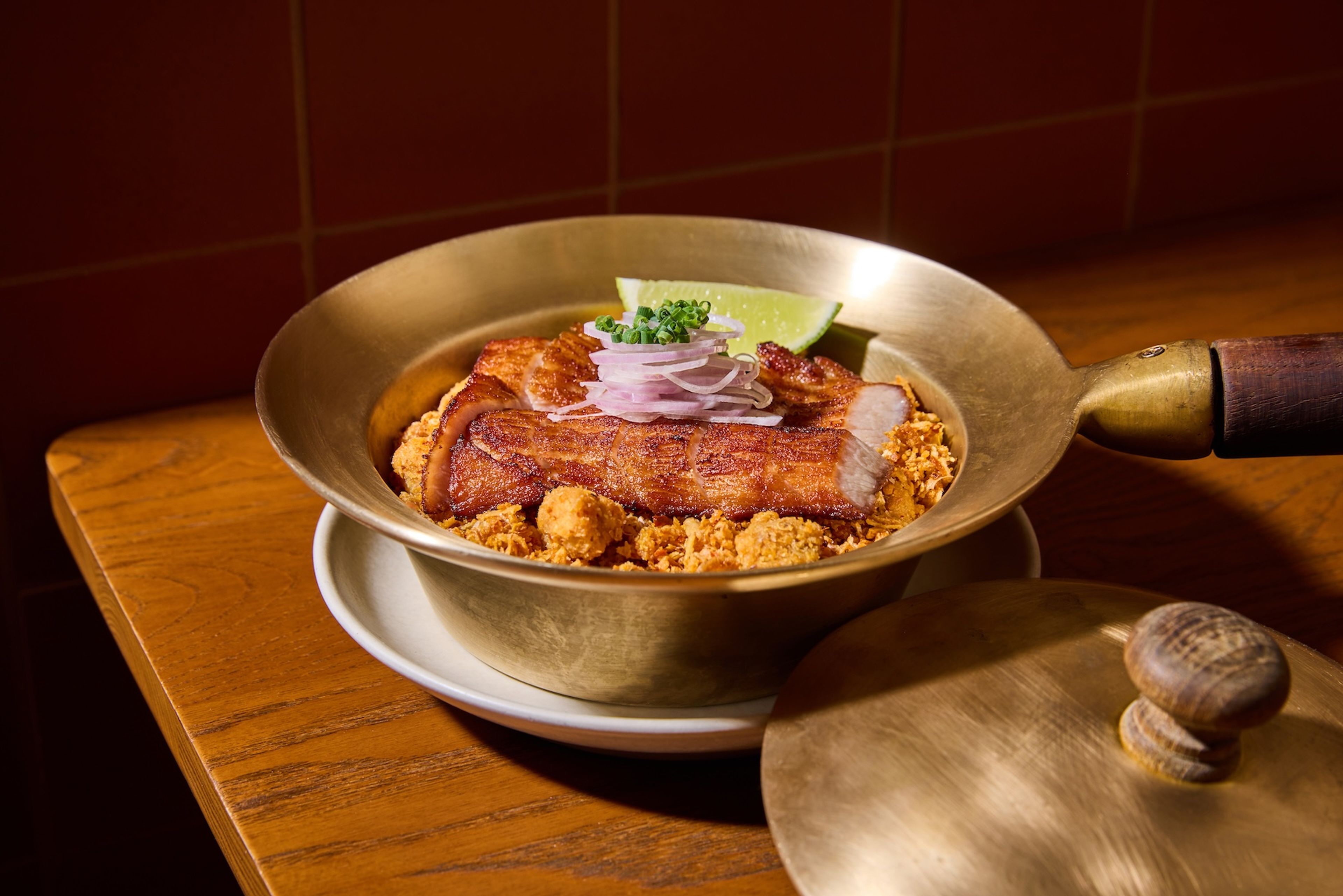 A golden pot with rice and pork