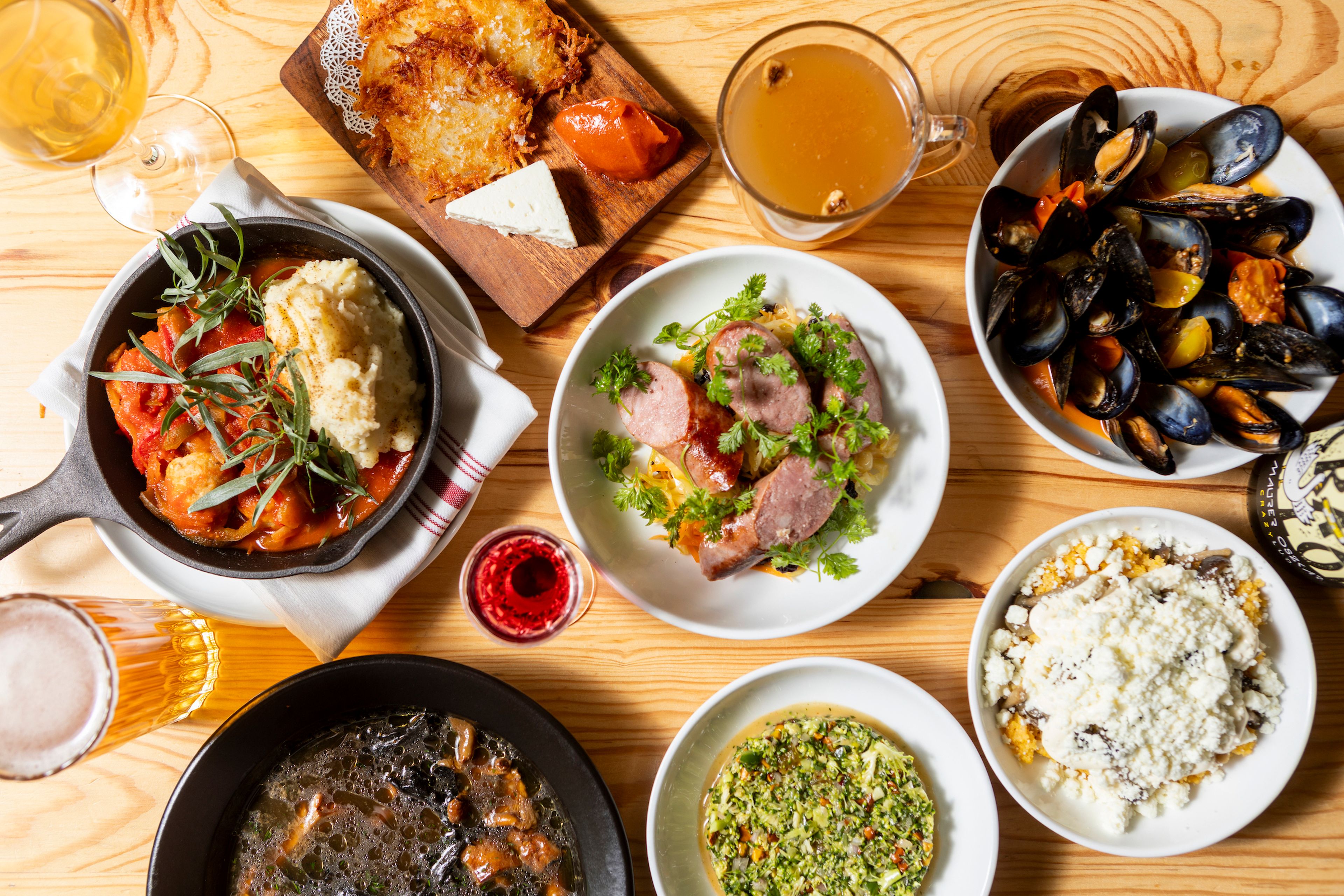 Different dishes on white plates on a wooden table