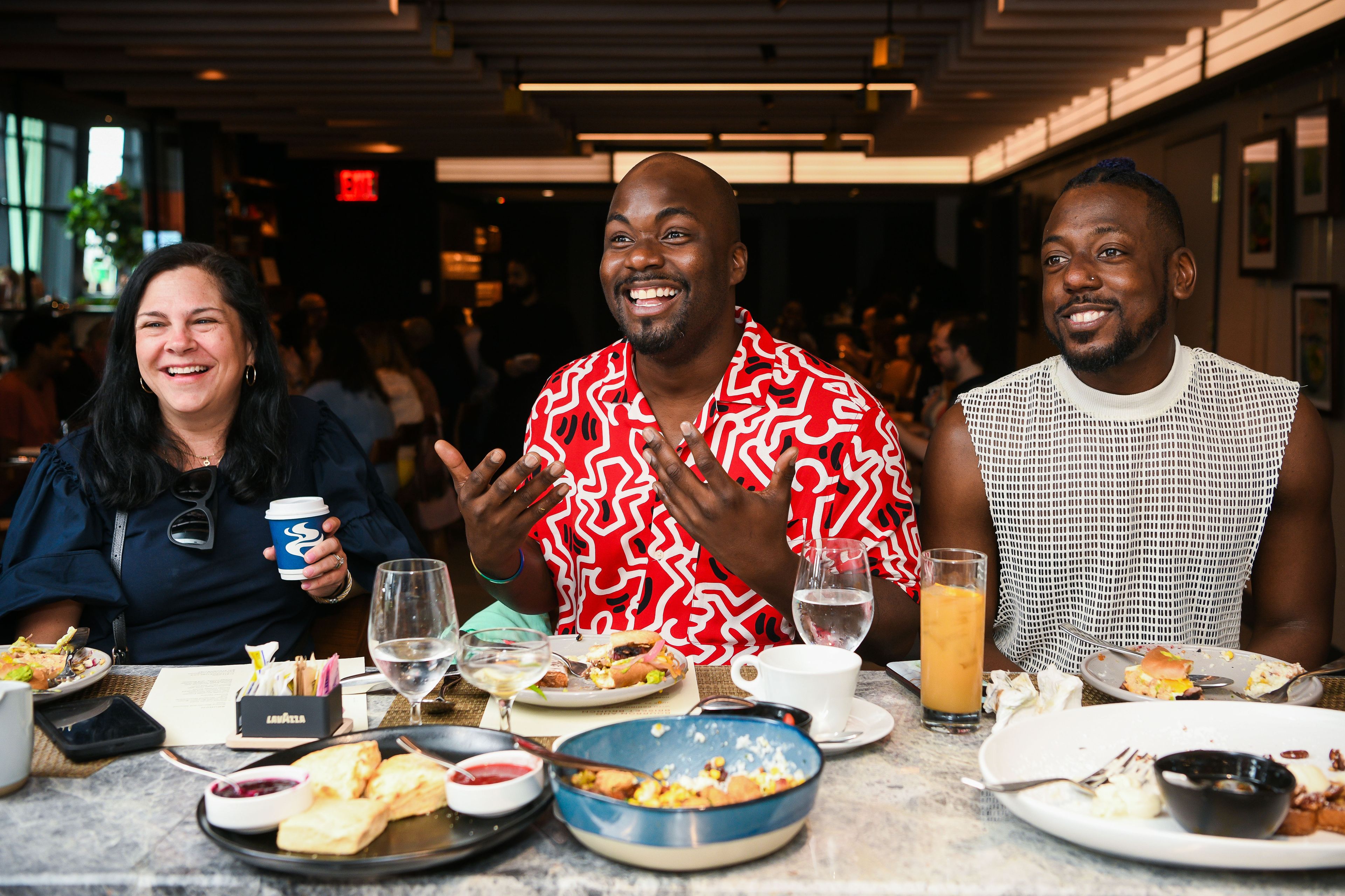 Three people seated at a chef's counter