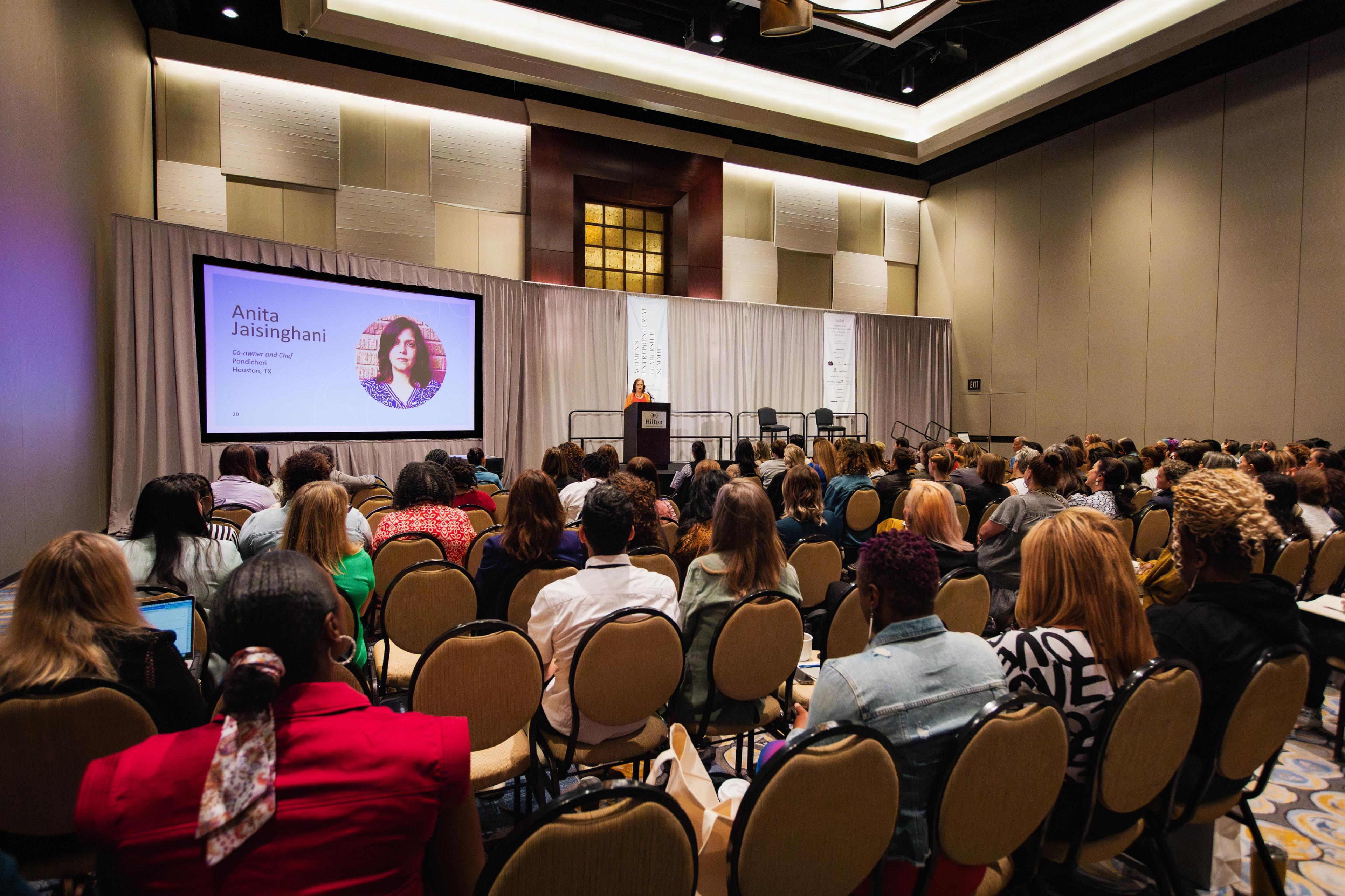 Speaker and audience at a conference