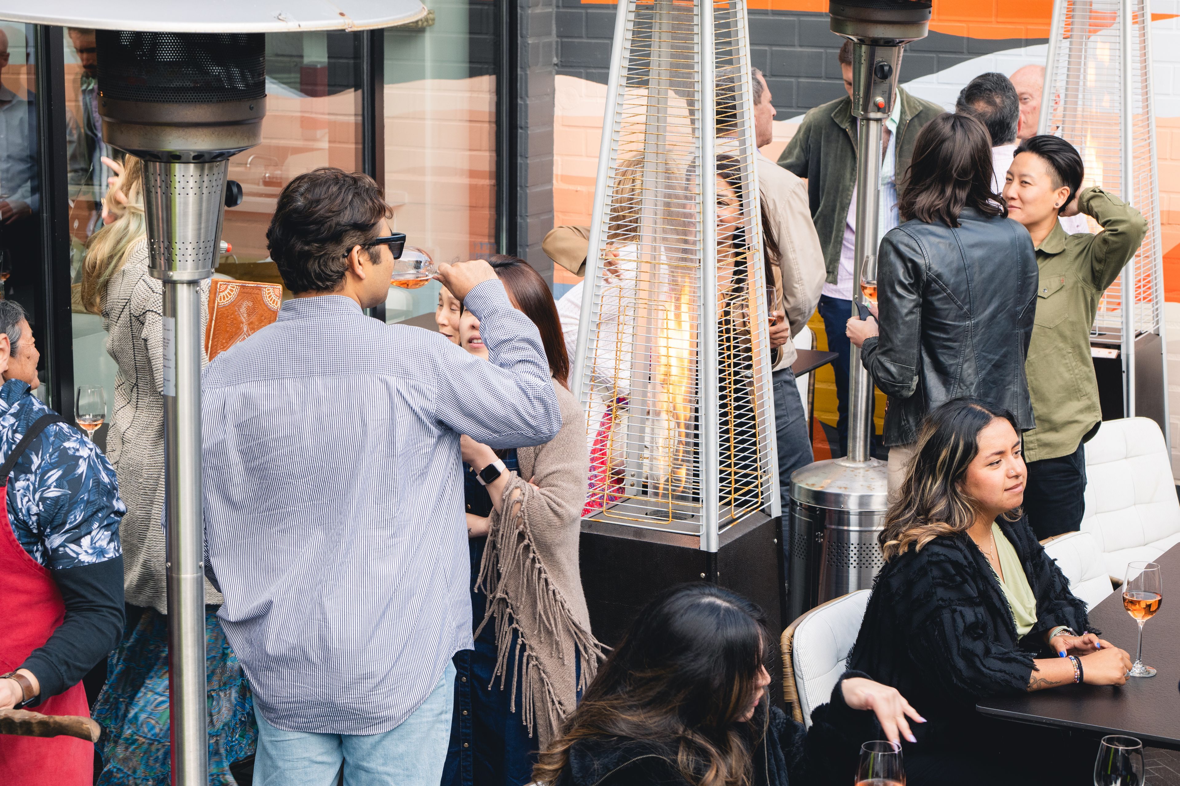 People drinking wine outside on a restaurant patio