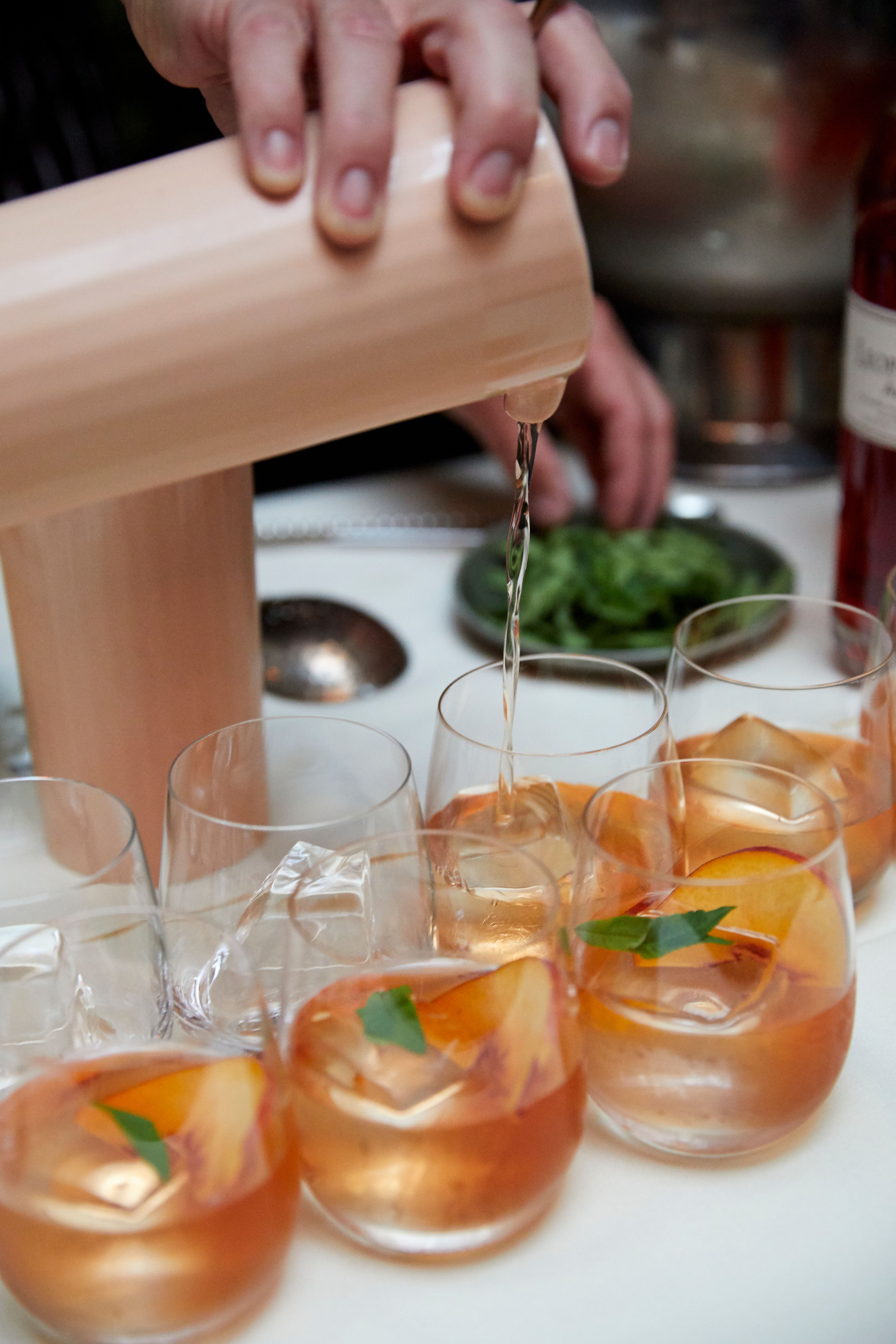 Batch cocktail being poured into glasses