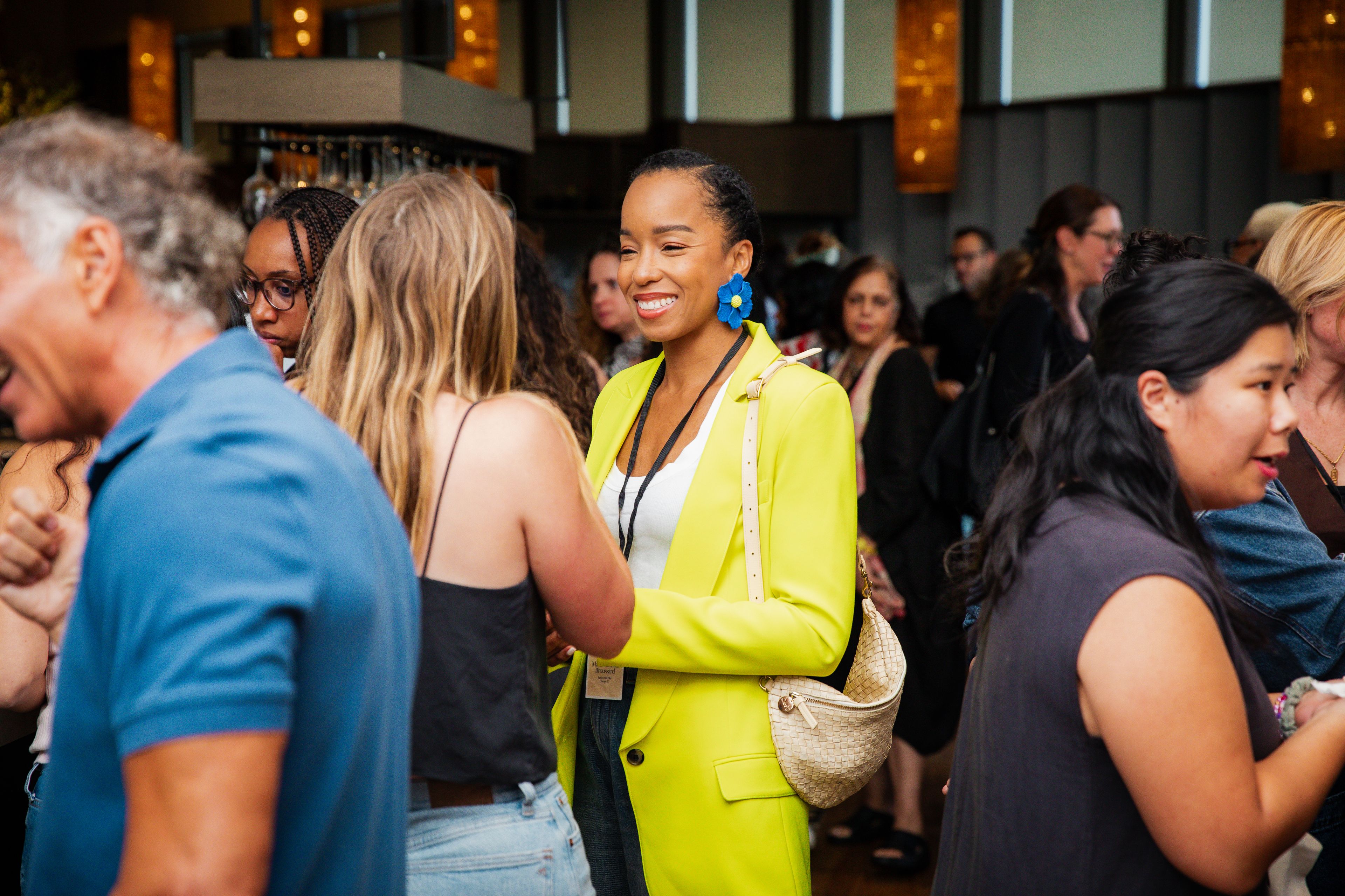 Woman in yellow blazer in a crowd