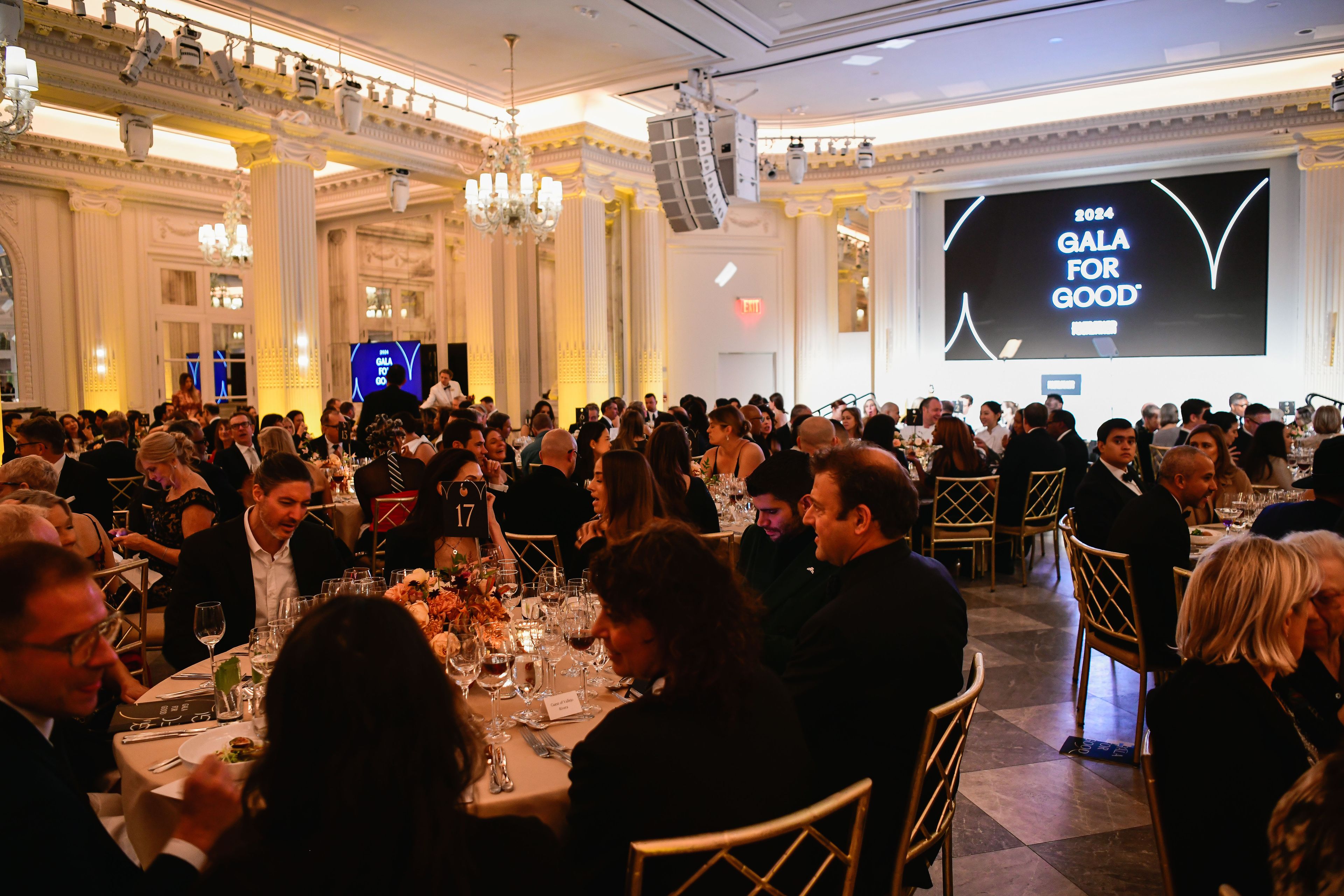 People seated at tables in a large ballroom