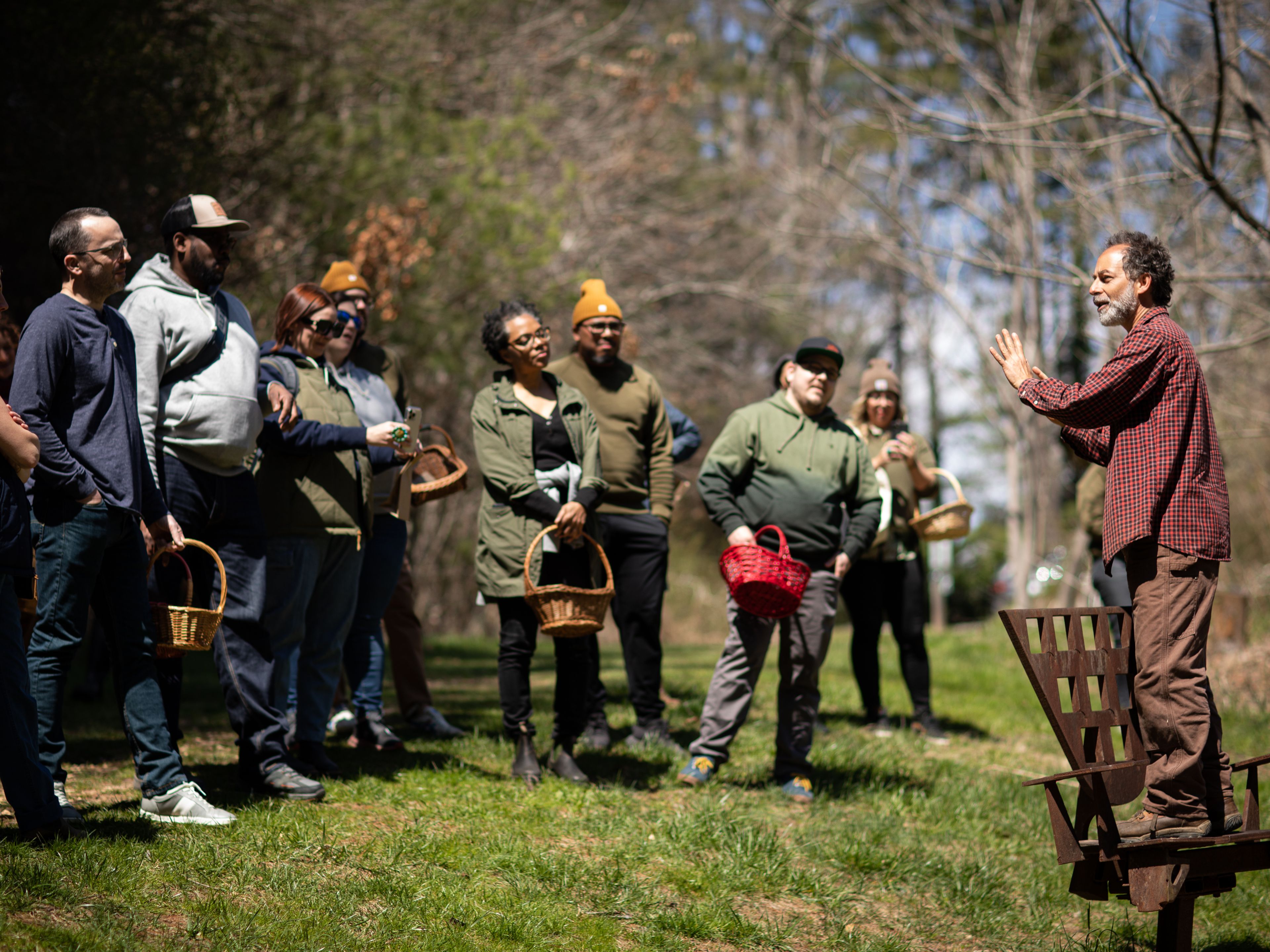 Group of people standing in a circle on a farm