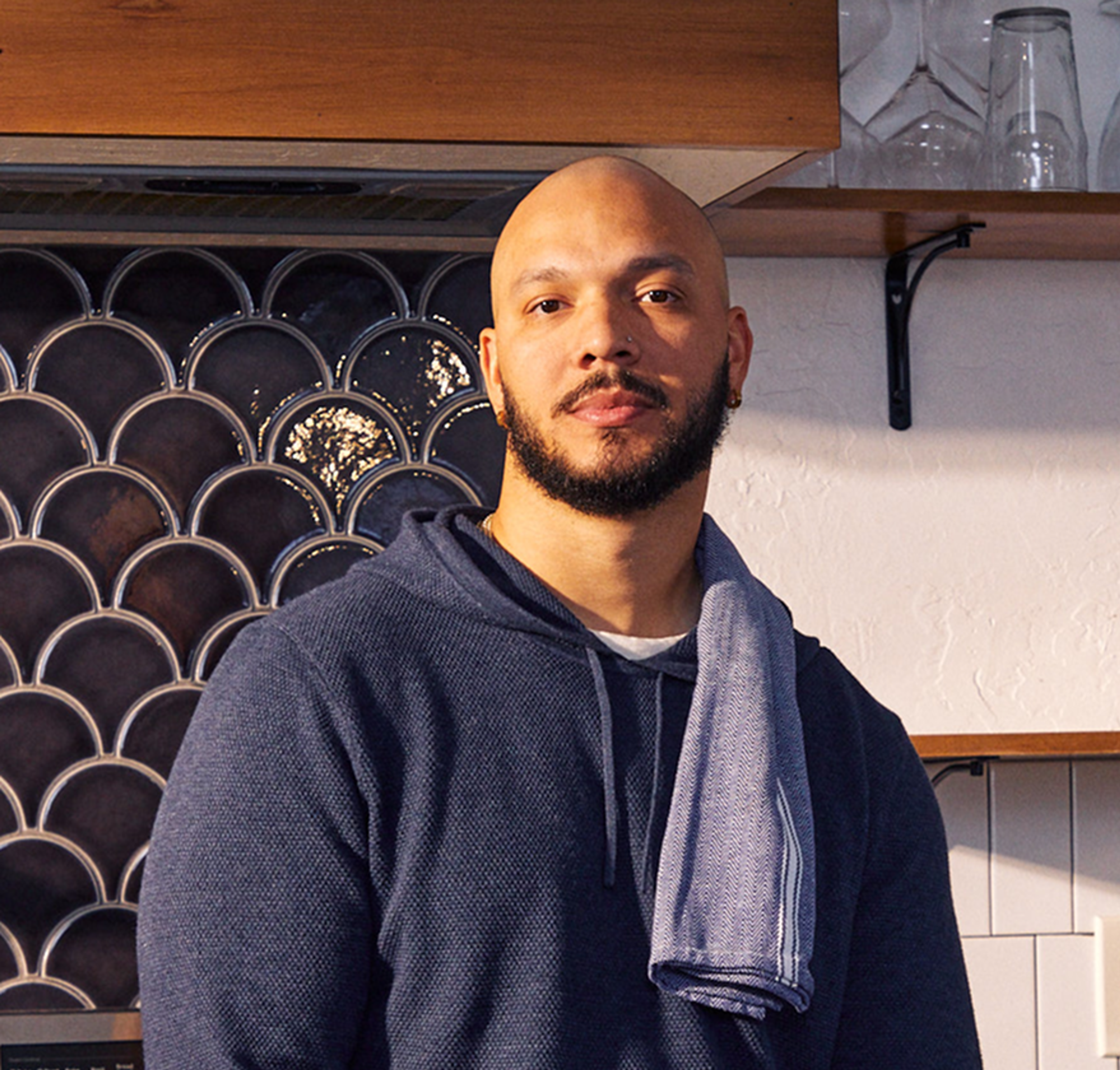 LT Smith standing in a kitchen, towel over his shoulder