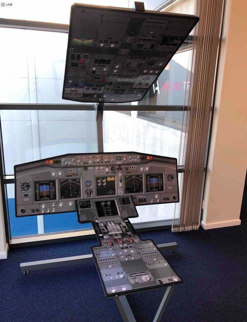 Practising 737 flows on a printed cockpit poster