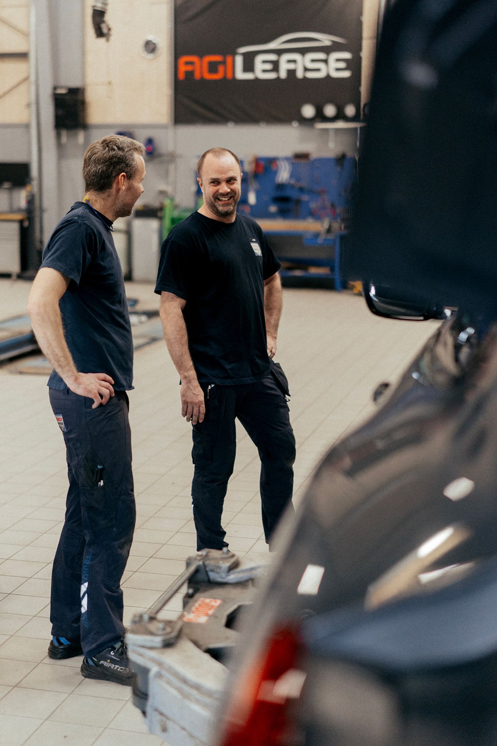 To medarbejdere taler sammen på værkstedet hos Bosch Car Service Viborg.