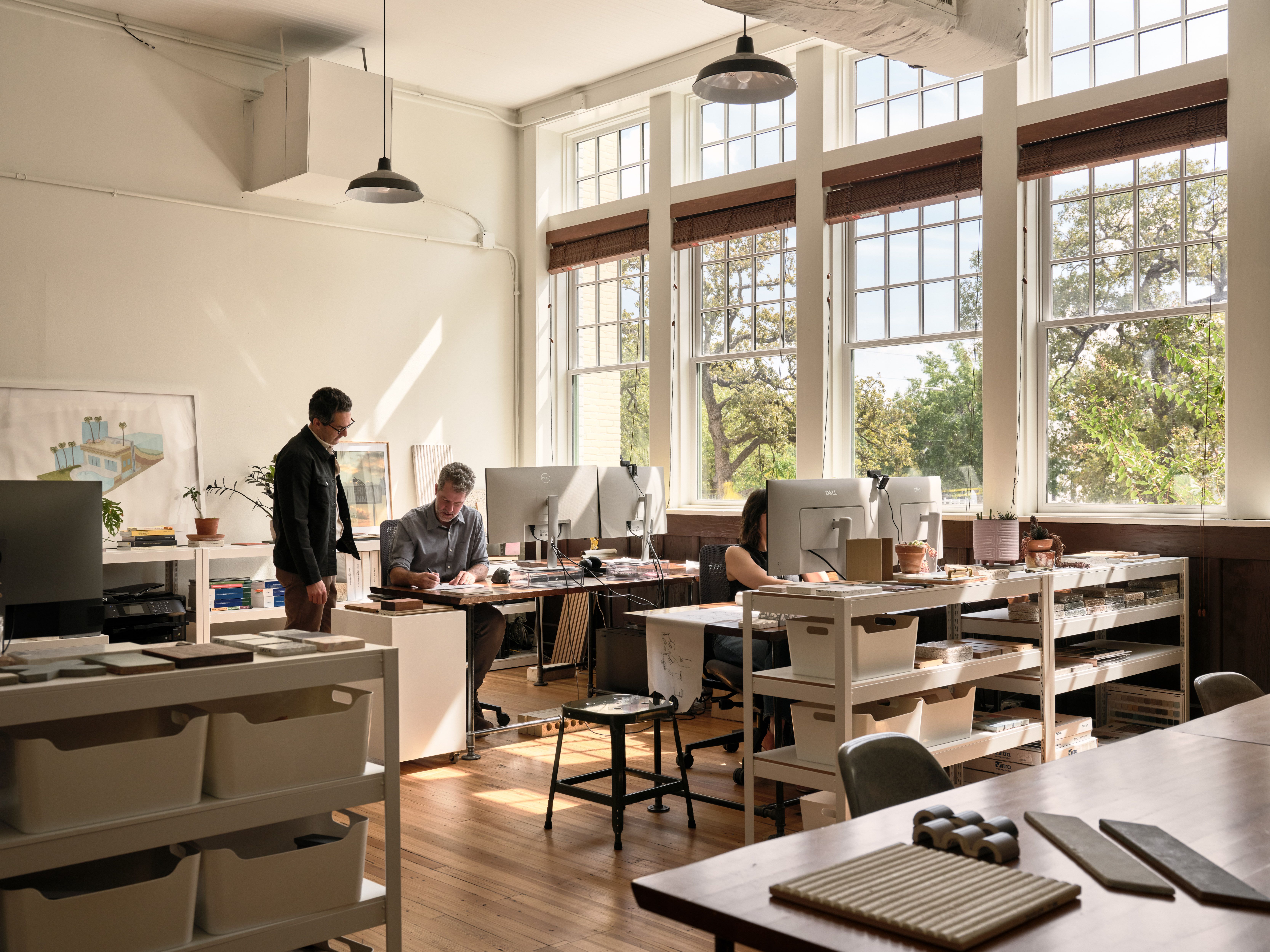 Nolan Bell's light-filled office space in Hyde Park, Austin Texas. Three people working at their desks.