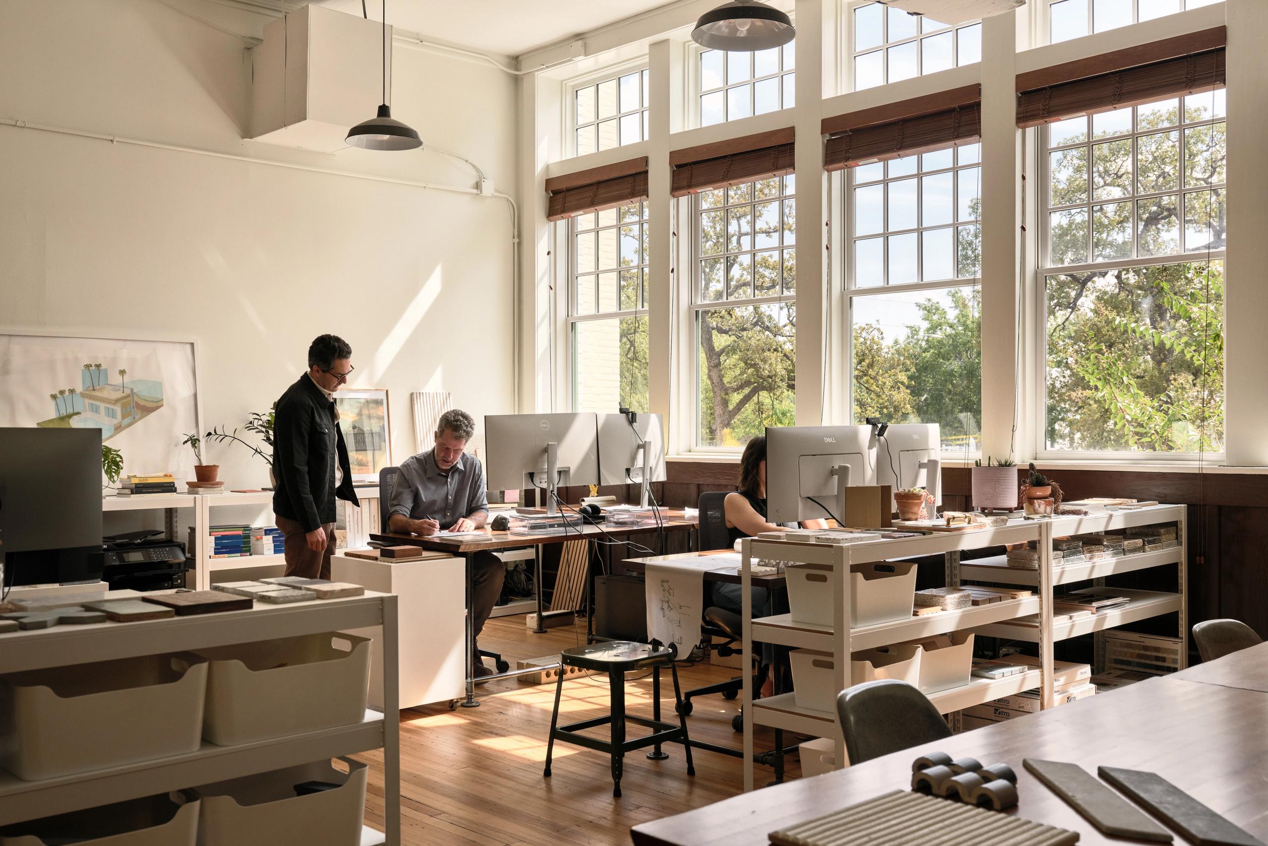 Nolan Bell's light-filled office space in Hyde Park, Austin Texas. Three people working at their desks.