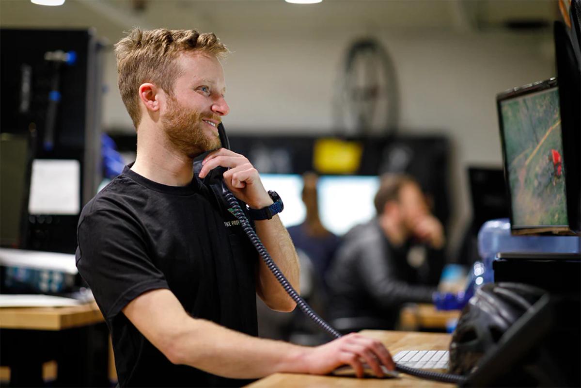 TPC employee smiling and talking on a phone