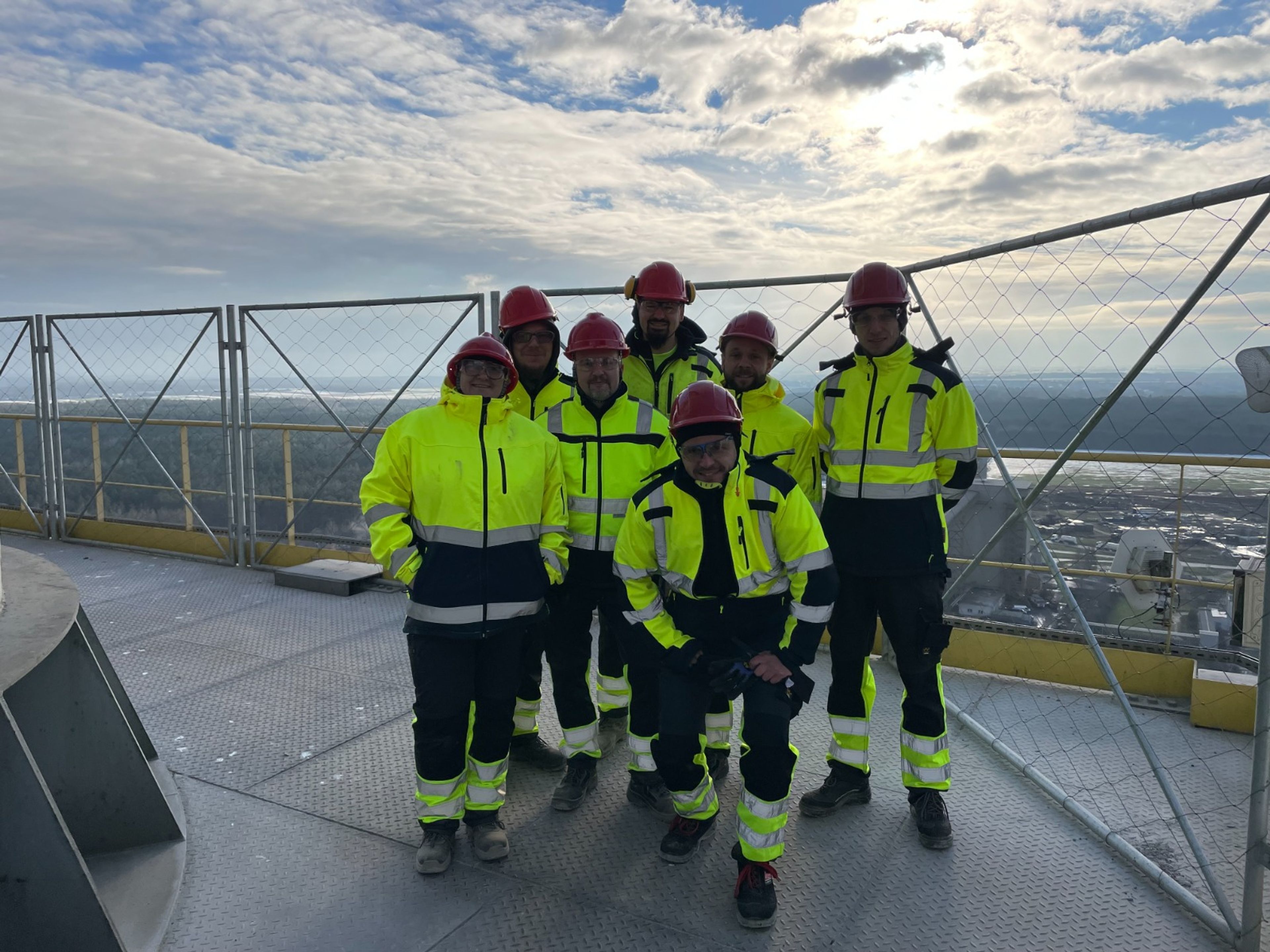 people on construction side on a roof 