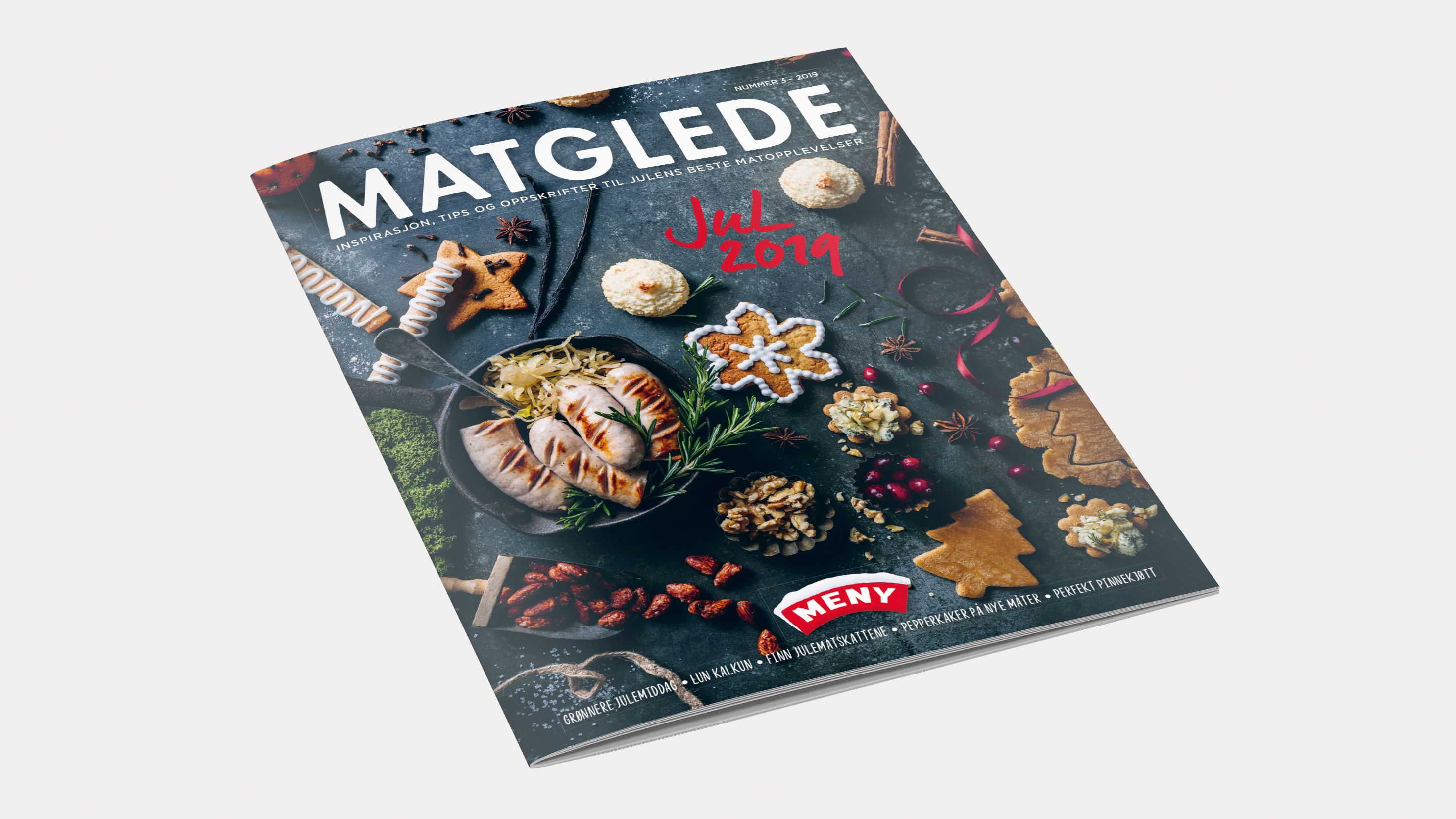 Forside av Matglede mockup jul 2019 med julebakst og pynt på en svart bakgrunn.