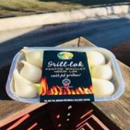 Pakke med grillokker med hvite ostekuler på et utendørsbord.