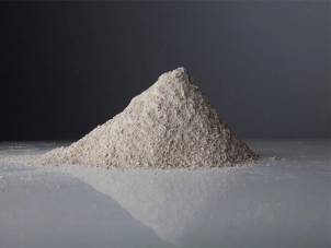 En haug av økologisk spesialkorn på en flat overflate med en mørk bakgrunn