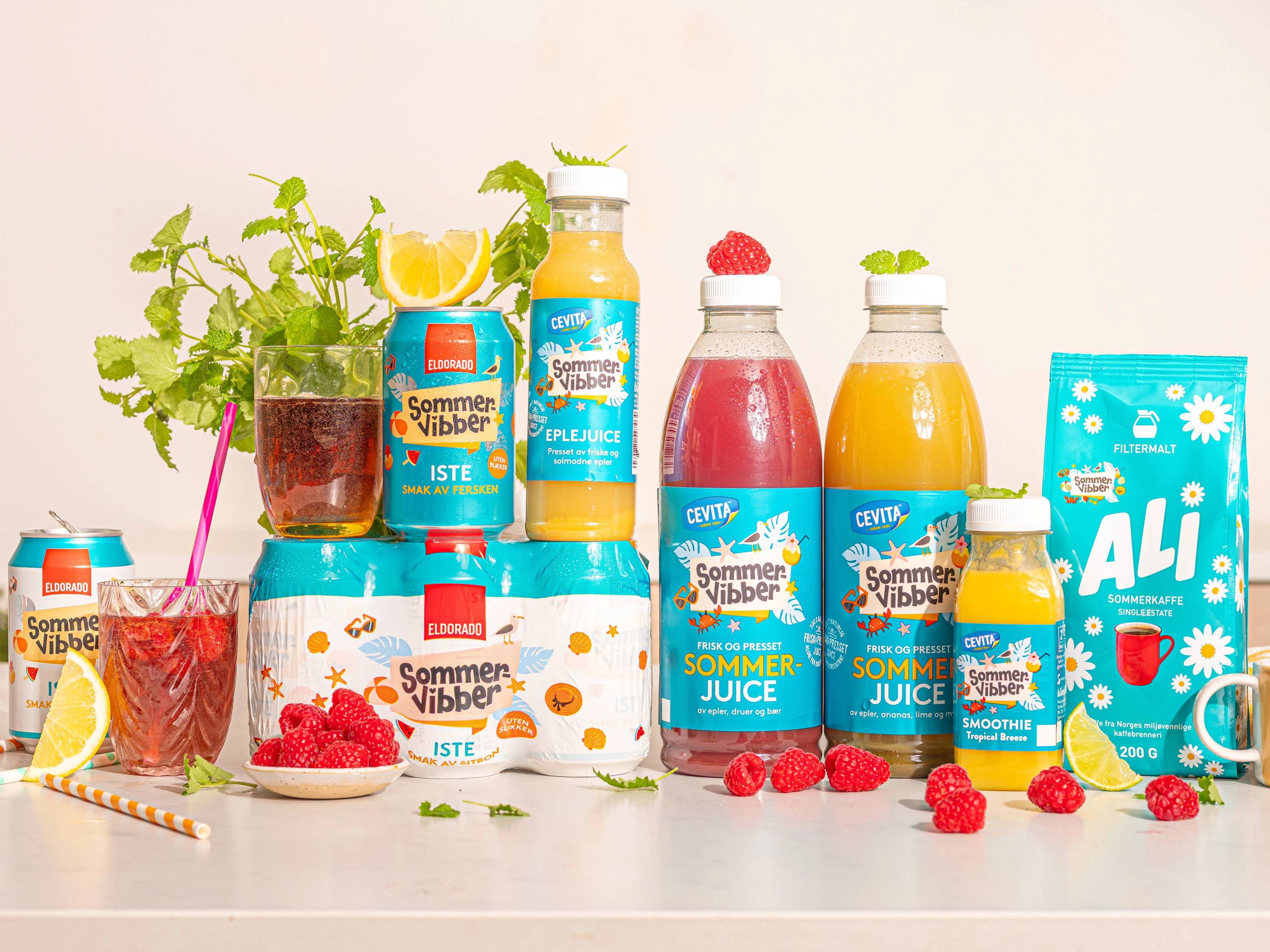 Et utvalg av sommerdrikker og frukt på en hvit bakgrunn, inkludert juice, bær og sitroner, med en plante i bakgrunnen.