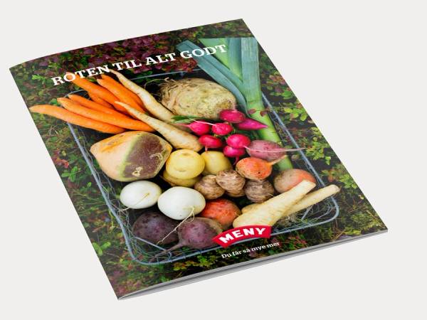 En bok med tittelen 'Roten til alt godt' ligger på en grønn, skogaktig bakgrunn, omgitt av ulike rotgrønnsaker og knoller.