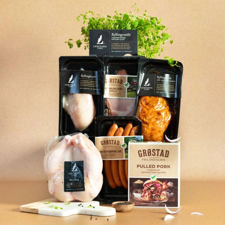 Kjøttprodukter og pølser fra Grøstad på et bord, med en plante i bakgrunnen, som illustrerer dyrevelferd.