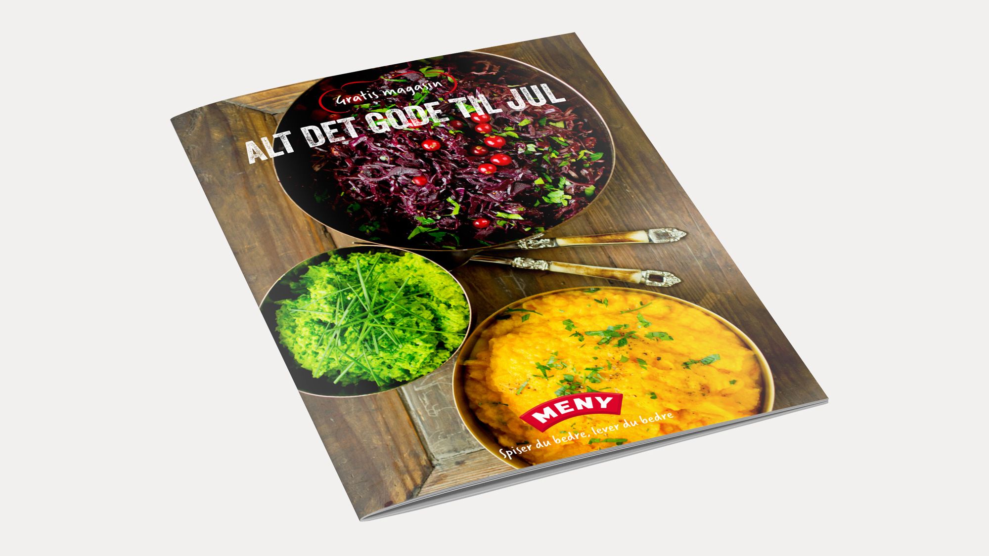 En kokebok med bilder av frukt og grønt til jul, med tittelen 'Alt det gode til jul' på forsiden.