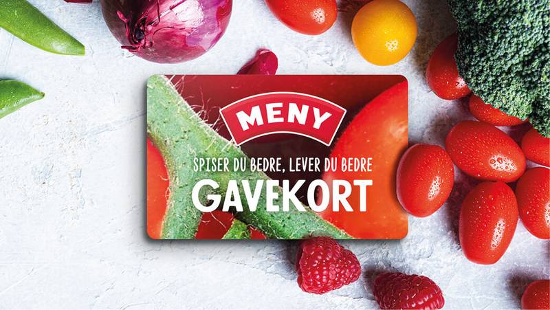 Et gavekort med teksten 'Meny' og bilder av grønnsaker og frukt rundt det