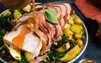 Baconstekt kalkunfilet servert med grønnsaker og poteter på en tallerken.