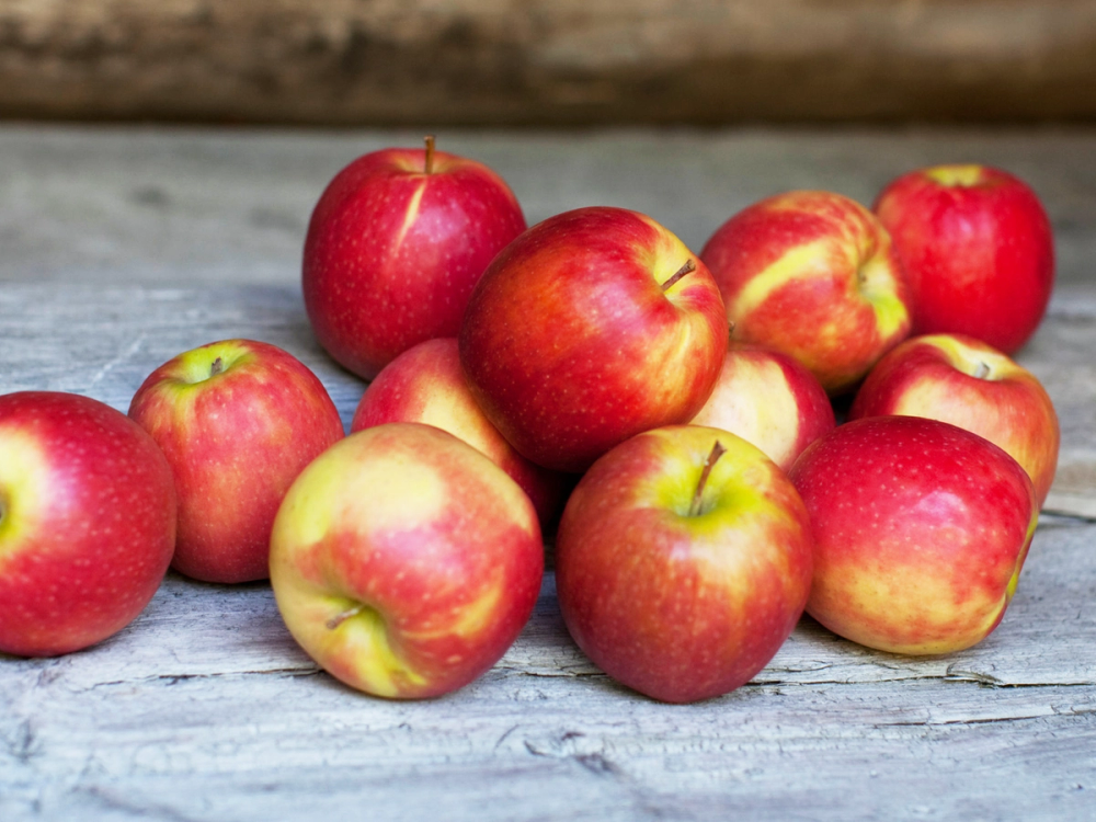 Norske epler ligger på en treplate utendørs.