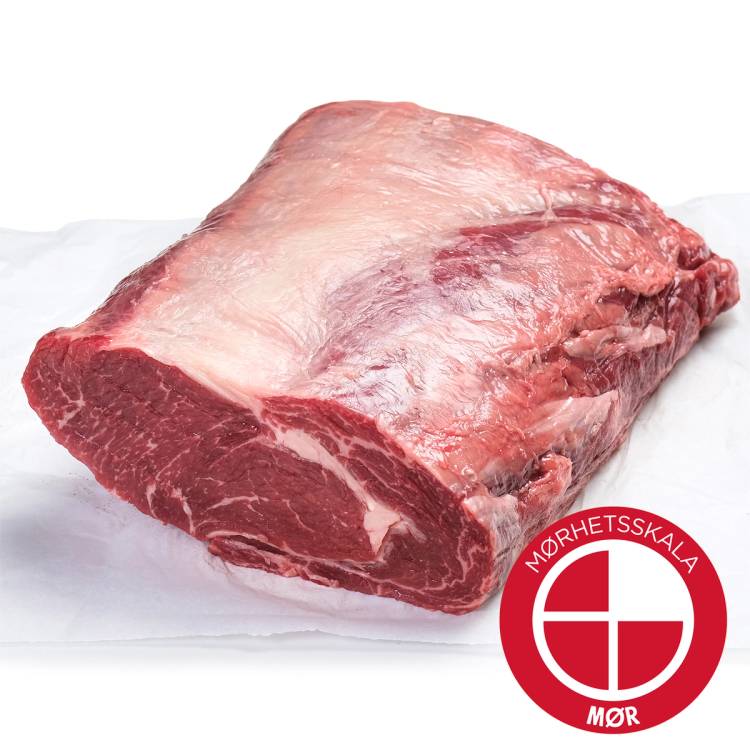 En hel Angus-entrecôte av kjøtt med marmorering og fett på toppen, pakket inn i hvitt papir.