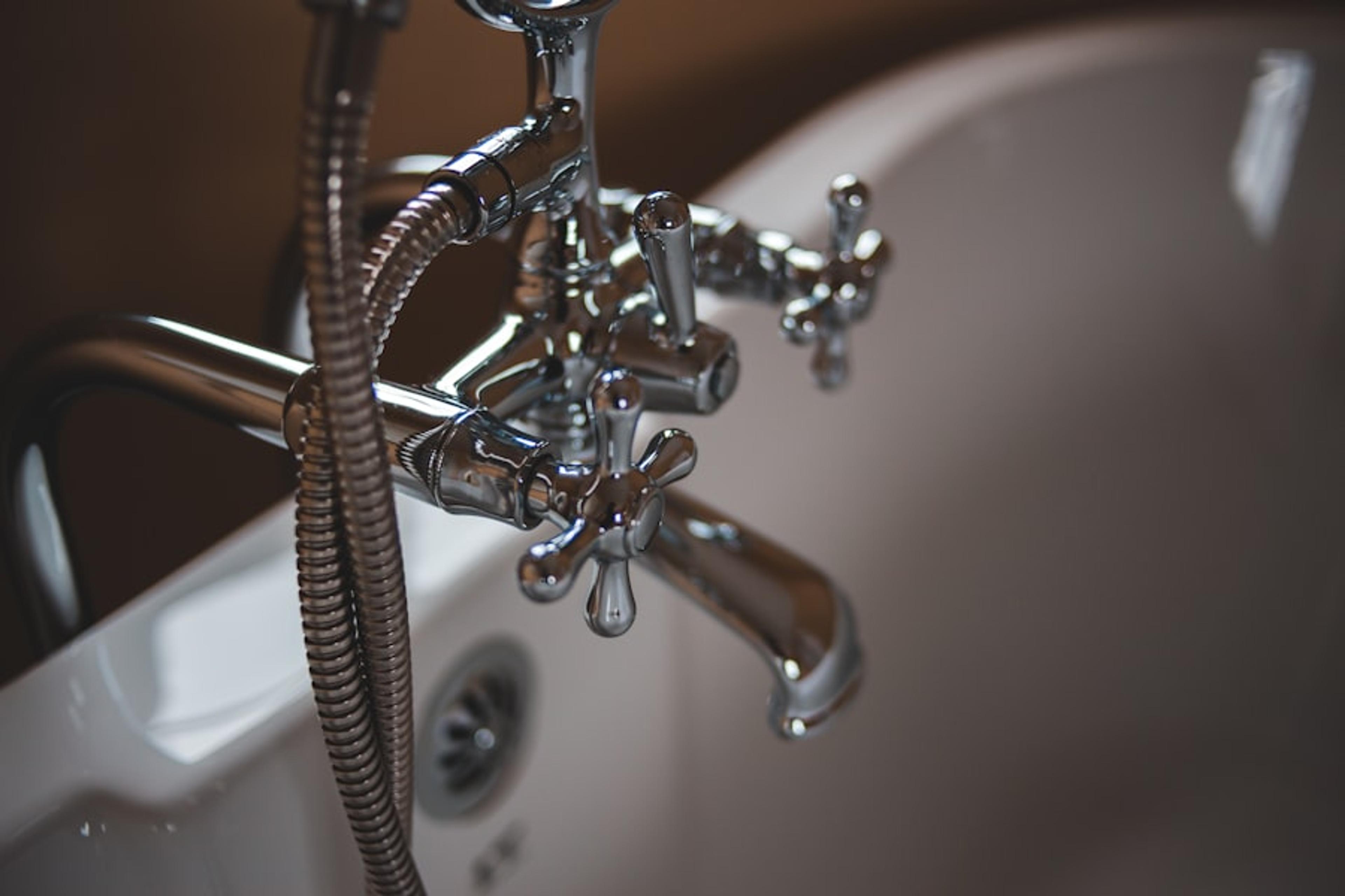 Plumber diagnosing plumbing under a kitchen sink