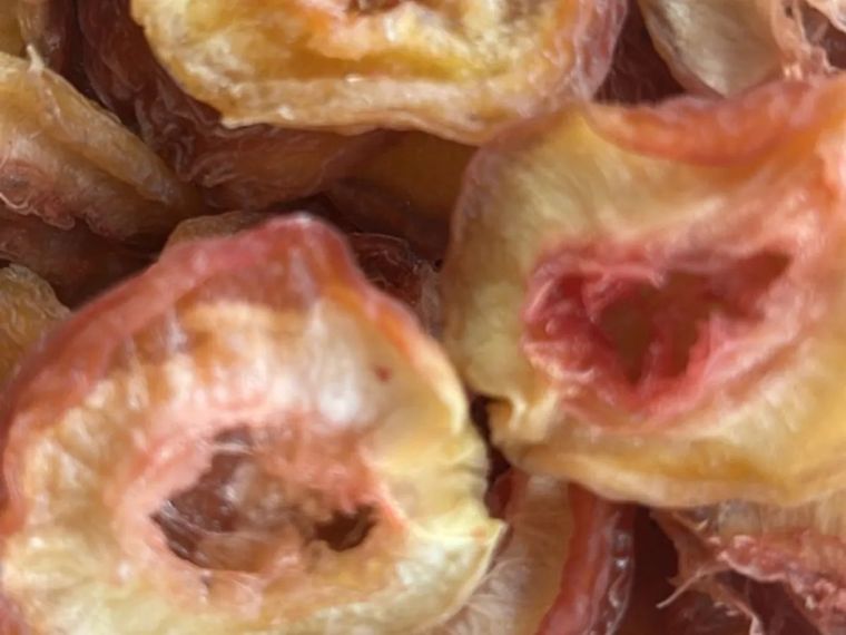 A close-up of sun-dried nectarine halves from Morialta Morsels at Woodforde, wrinkled and golden-pink