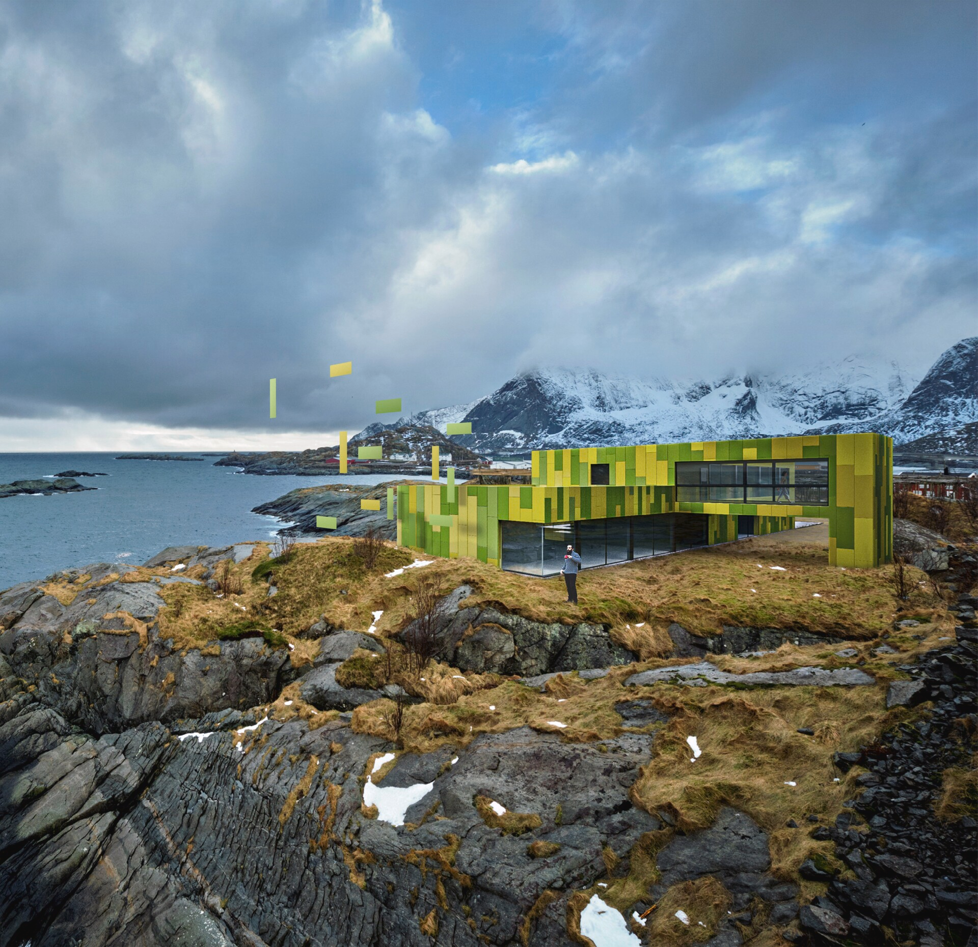 a man stands in front of a green building with mountains in the background