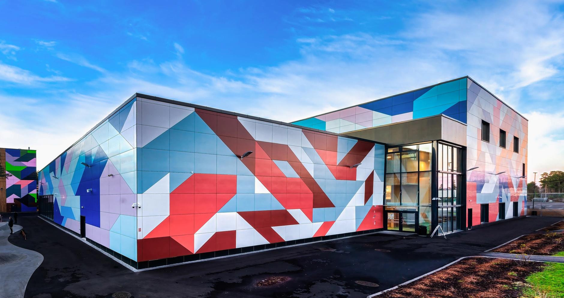 a building with a geometric pattern painted on the side