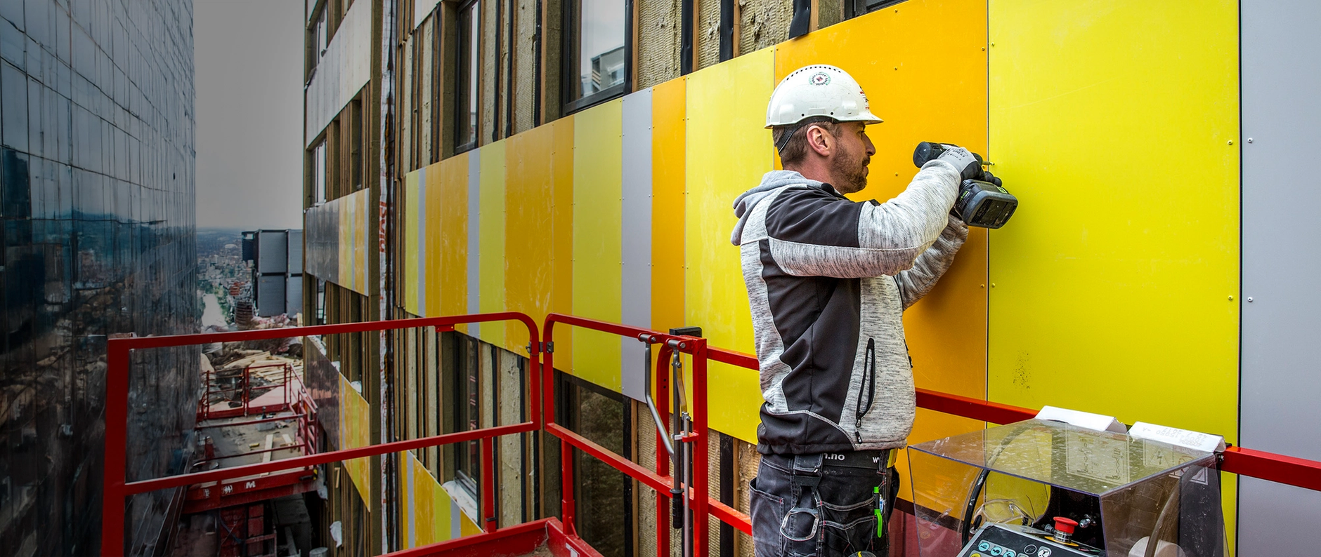 a man wearing a hard hat is working on a building
