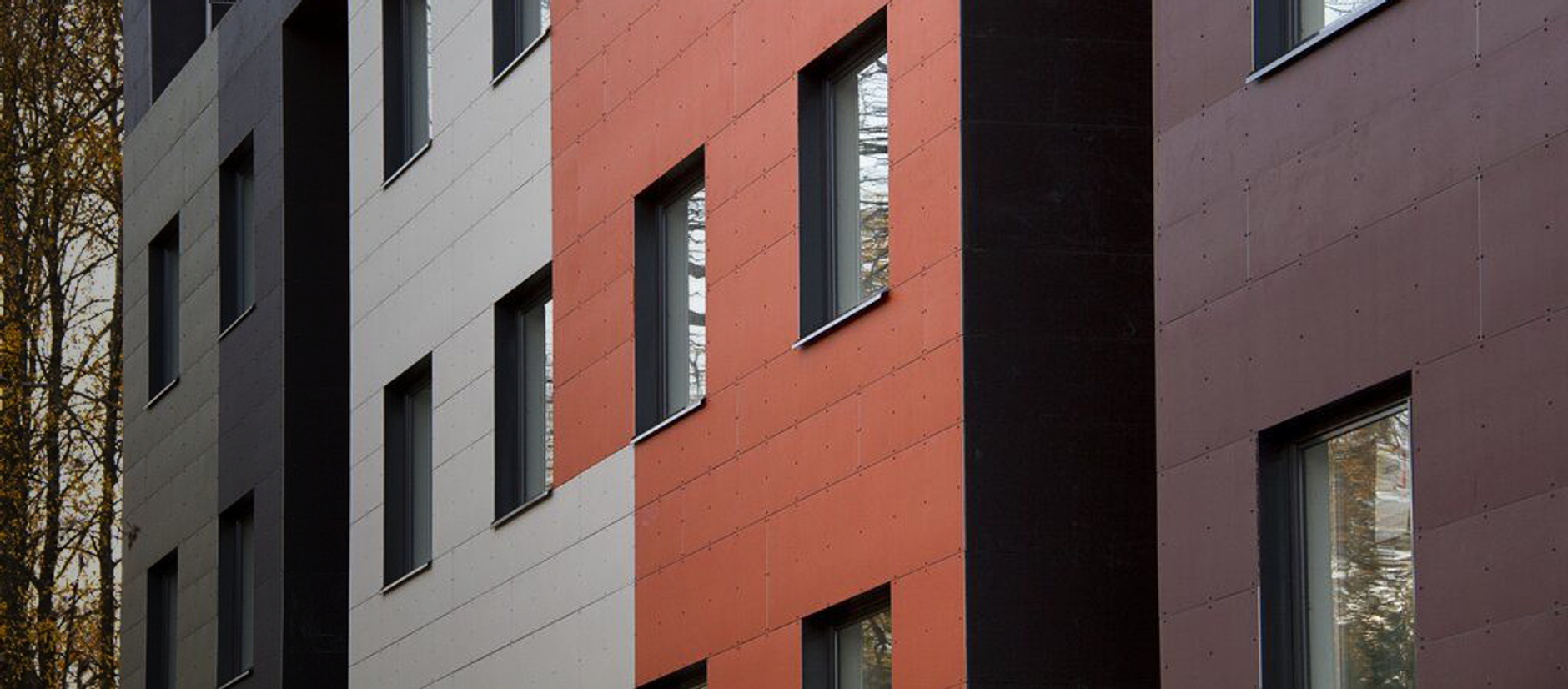 a row of buildings with different colors and sizes of windows