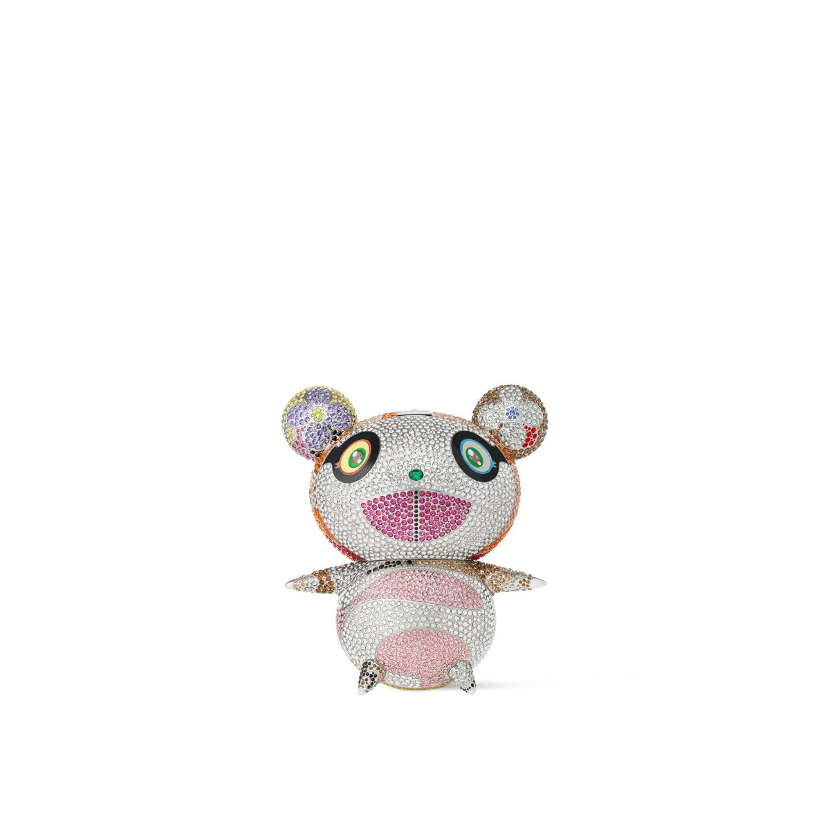 A small seated bear figure entirely covered in fine pastel crystals, with large round eyes and a pink muzzle.