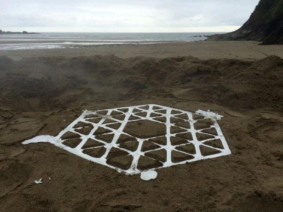 he Event Recorded in Metal: The raw, geometric web of the Pewter Stool cooling inside its sand mold, capturing the precise moment gravity and hydrology solidify into functional form.