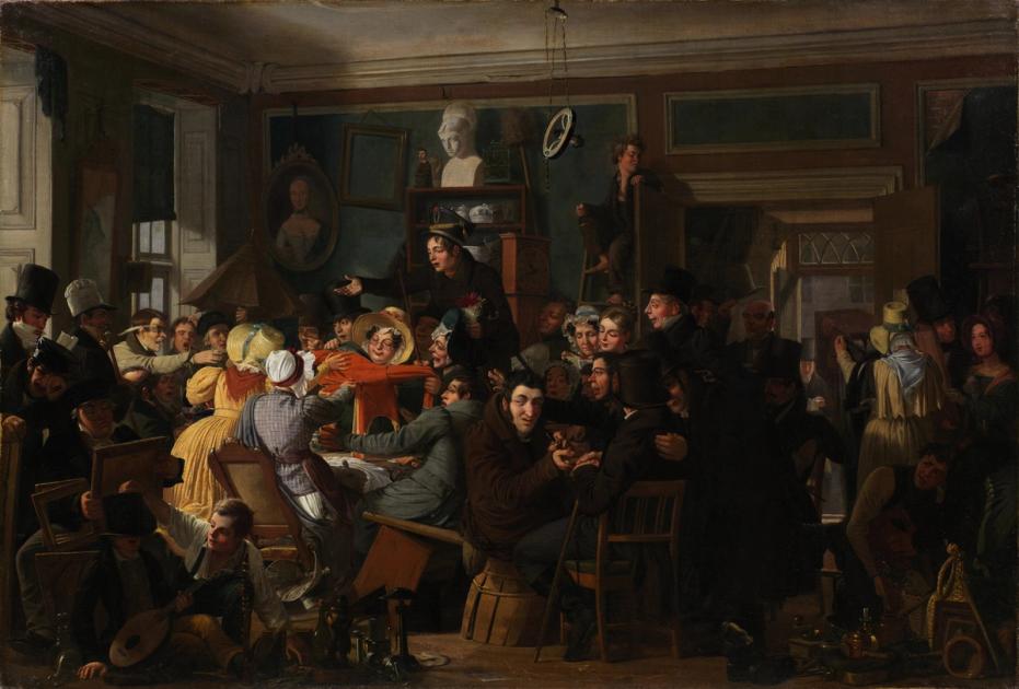 A crowded nineteenth century auction room, painted in warm dark tones, with buyers pressed together around a coat held up for inspection, and chairs, pots, framed pictures and a lute stacked on the floor.