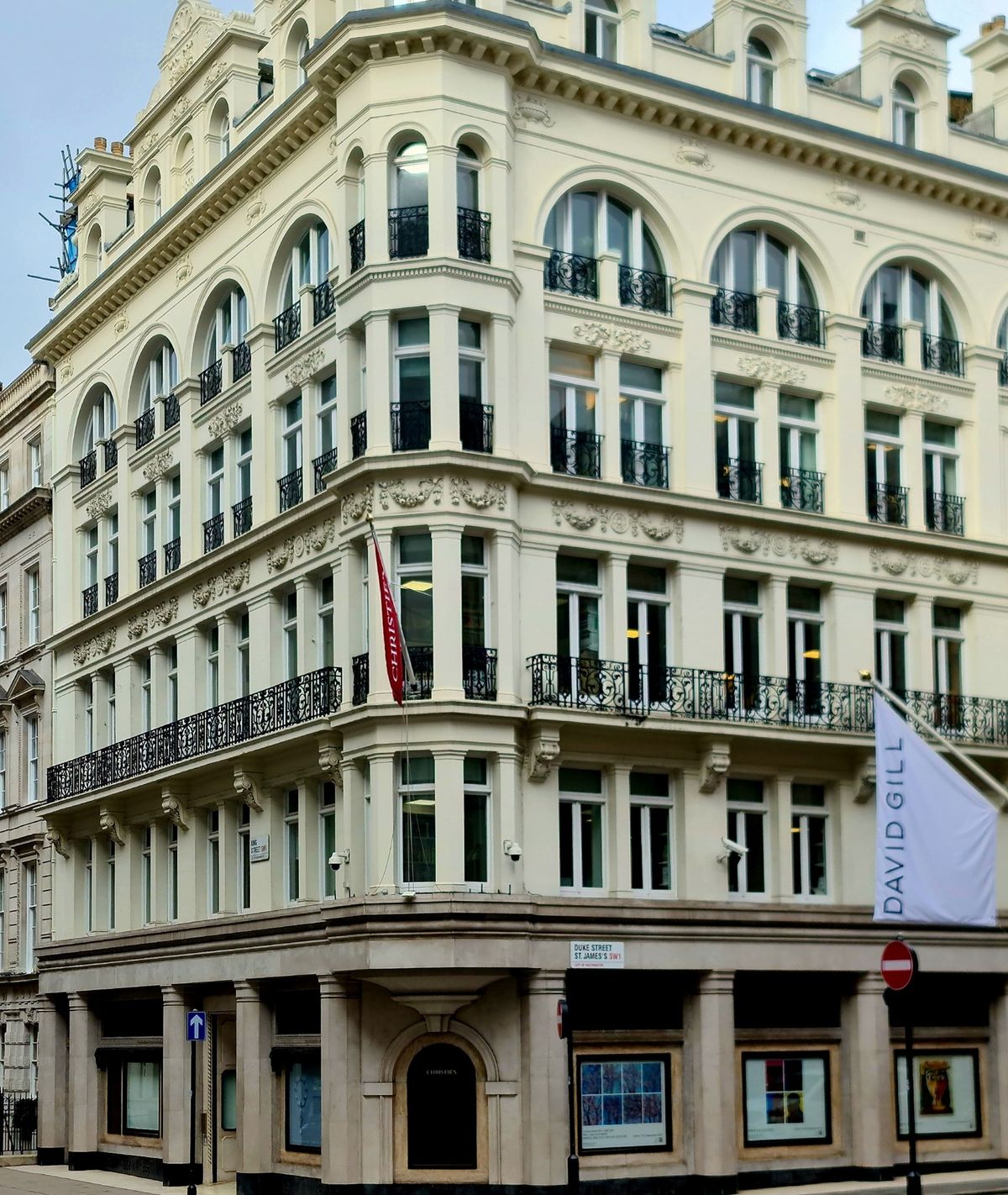 The Christie's building on the corner of King Street and Duke Street, St James's, London, with a red Christie's banner above the entrance.