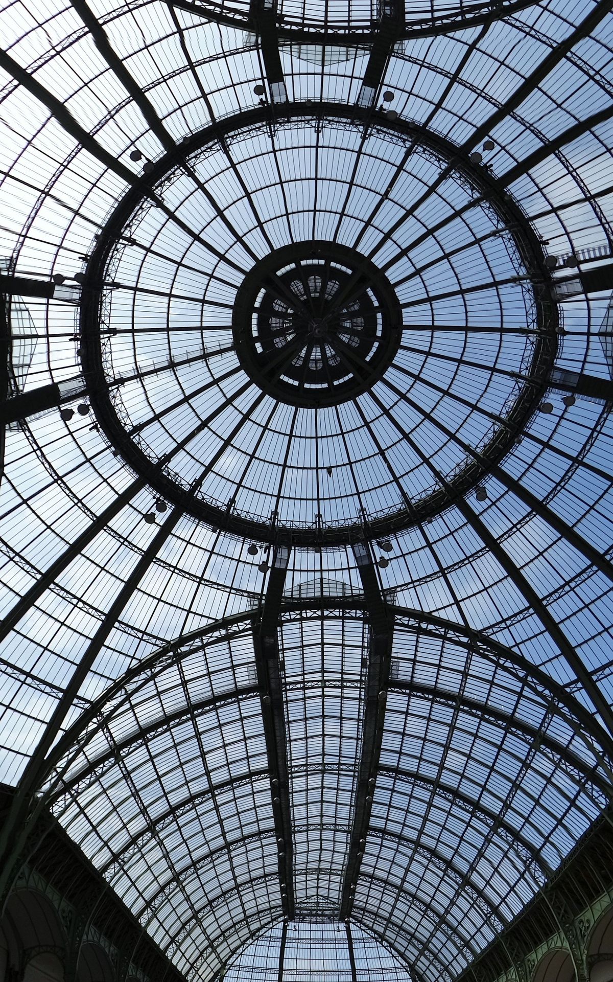 The vast glazed nave of the Grand Palais seen from below, open and empty of stands.