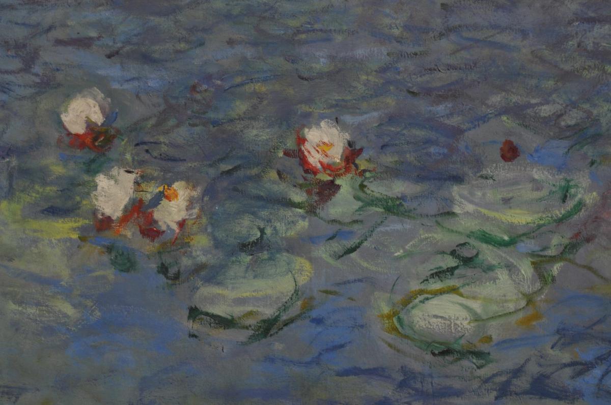 A detail of a large water lily mural in a museum gallery.