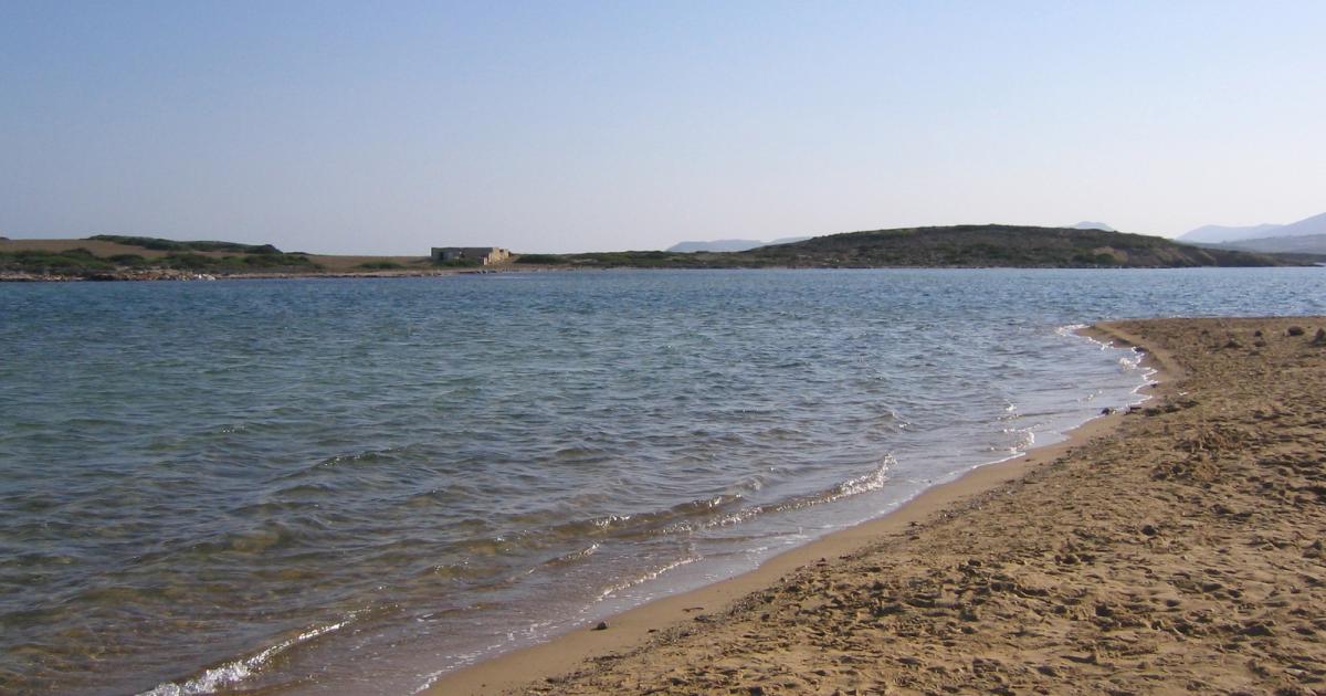 Antiparos beach with turquoise water and rocky shoreline, Cyclades, Greece