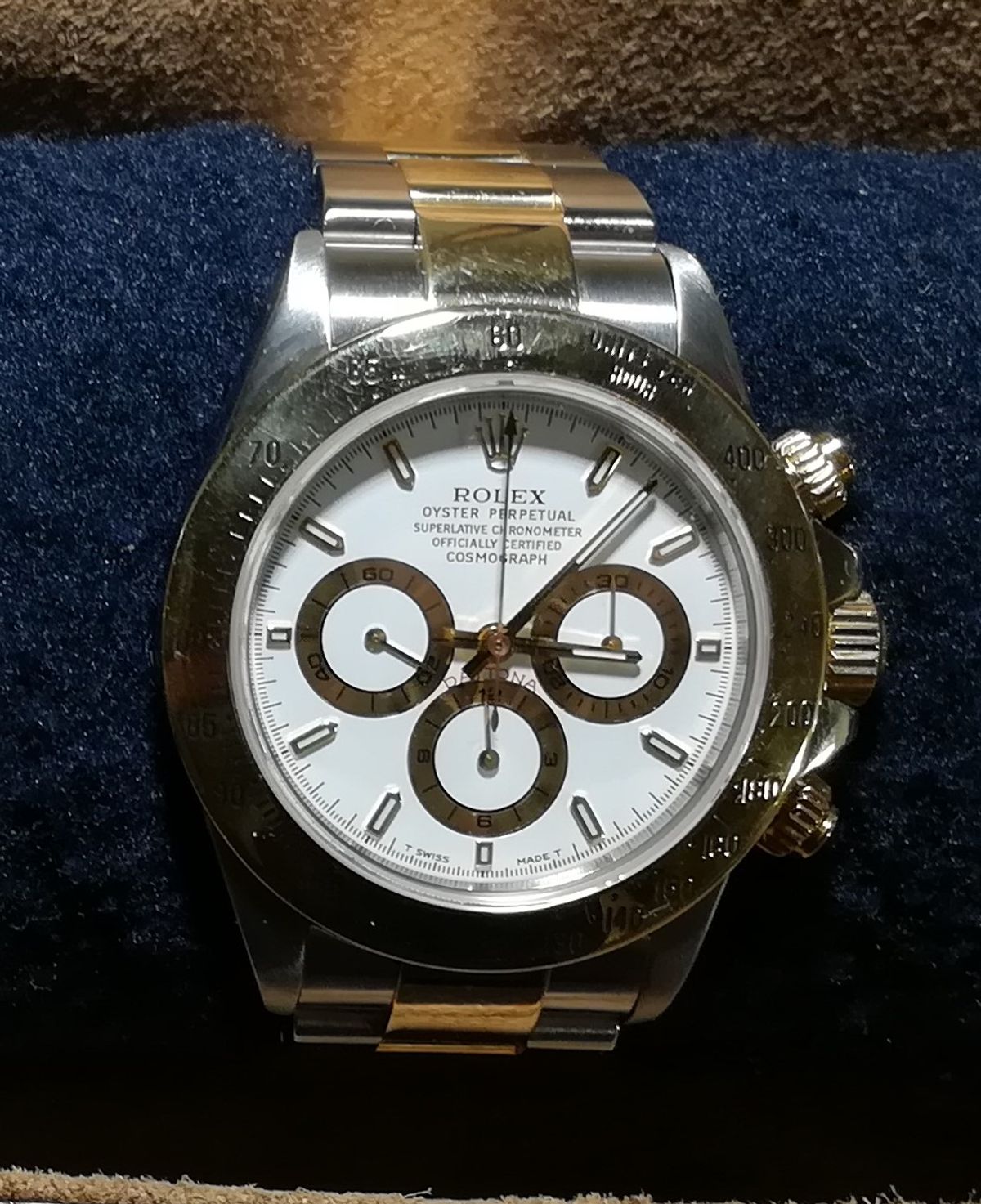 A steel and gold Rolex Daytona reference 16523 photographed at an angle in natural light, plainly an owner's own photograph rather than a studio plate.